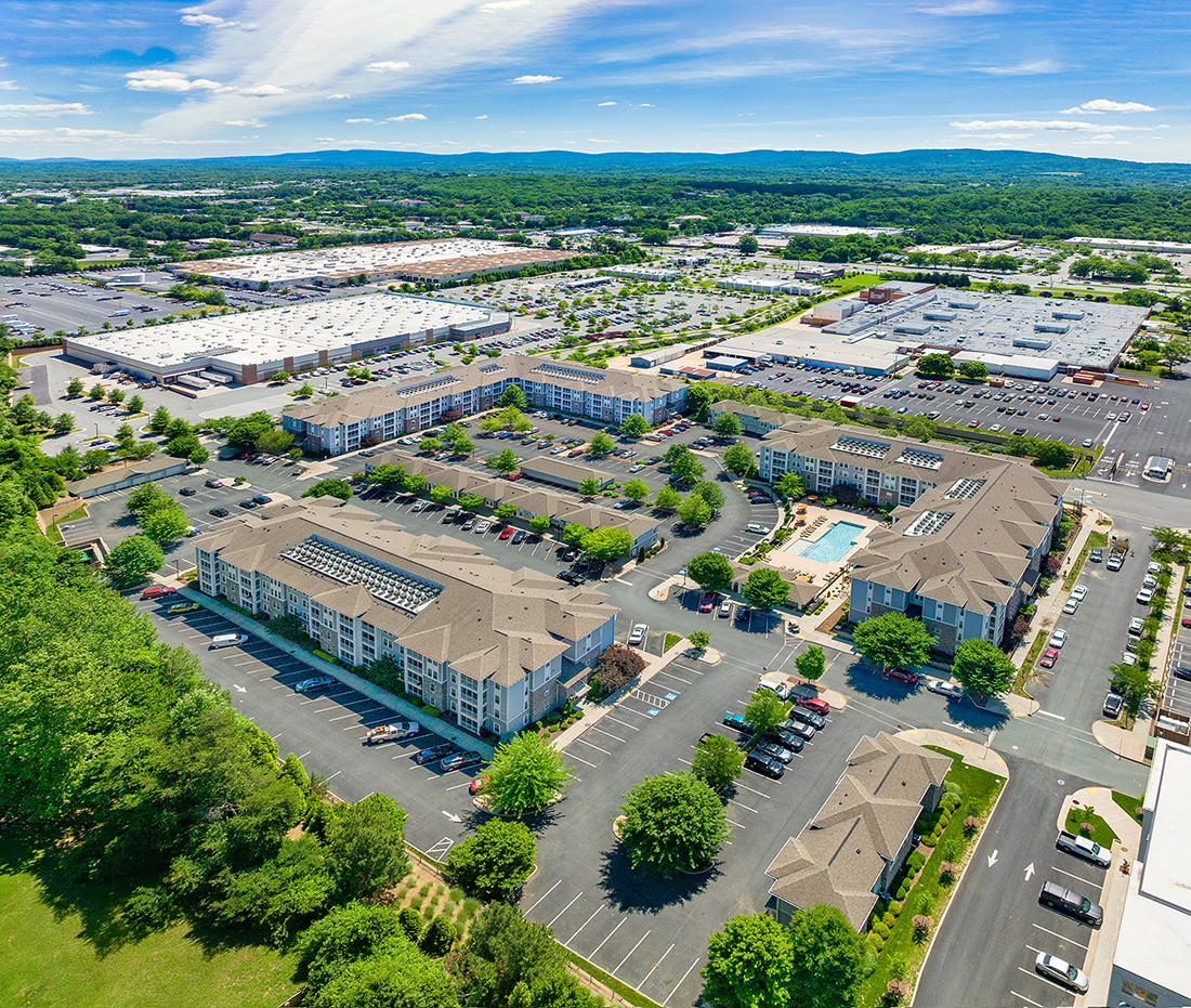 an aerial view of a city with buildings and parking lots