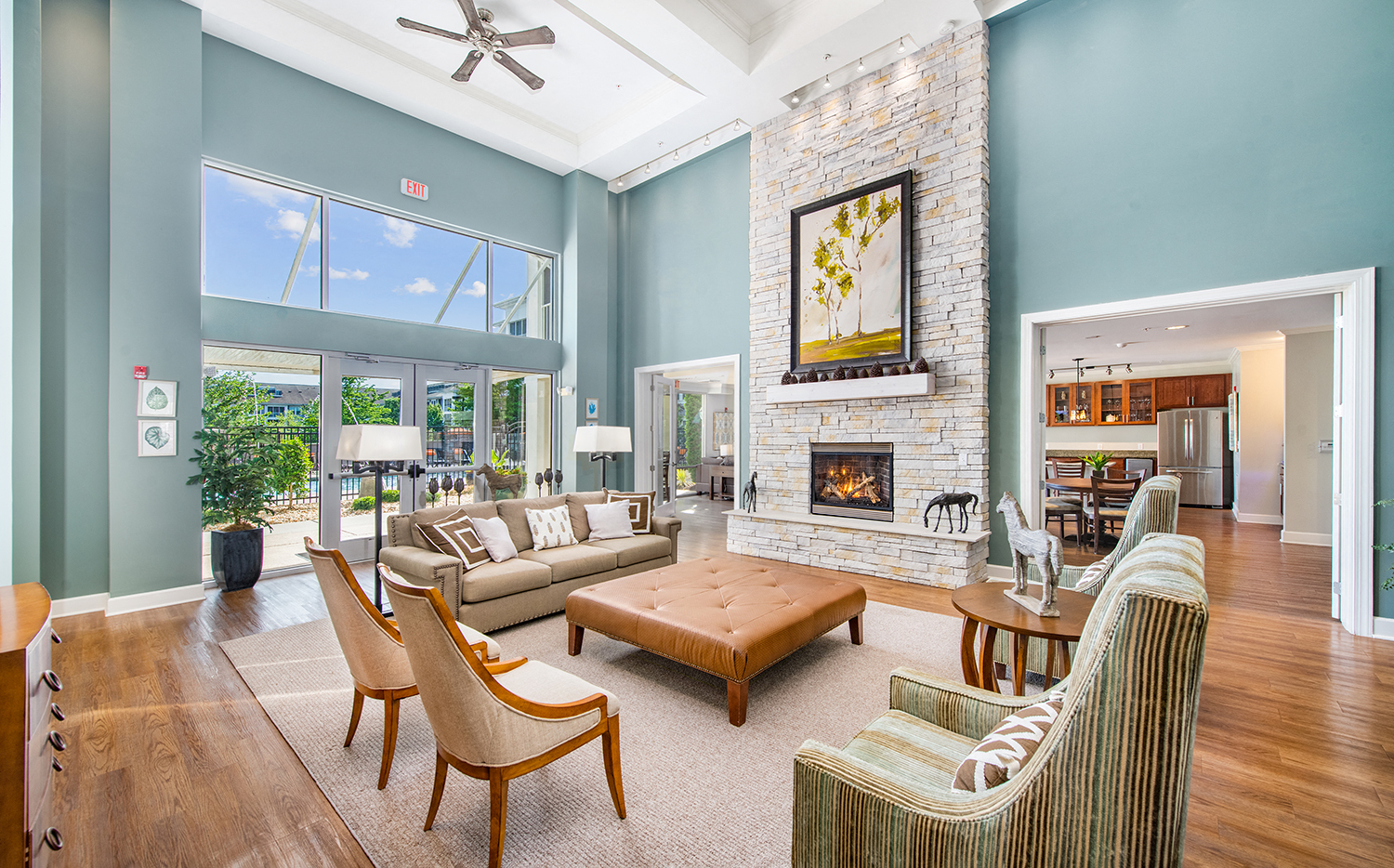 a living room with blue walls and a stone fireplace