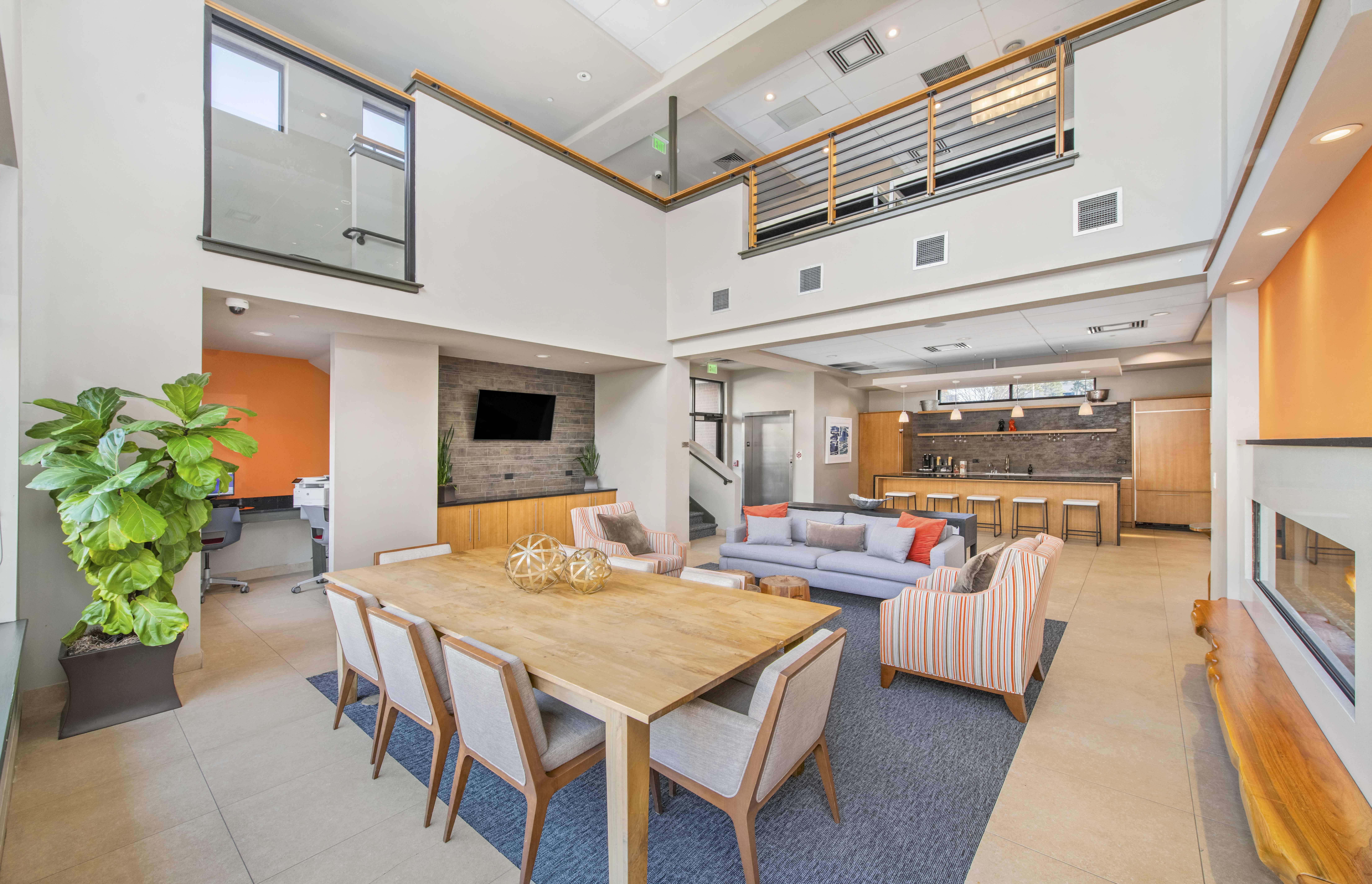 a living room and dining room with a table and chairs