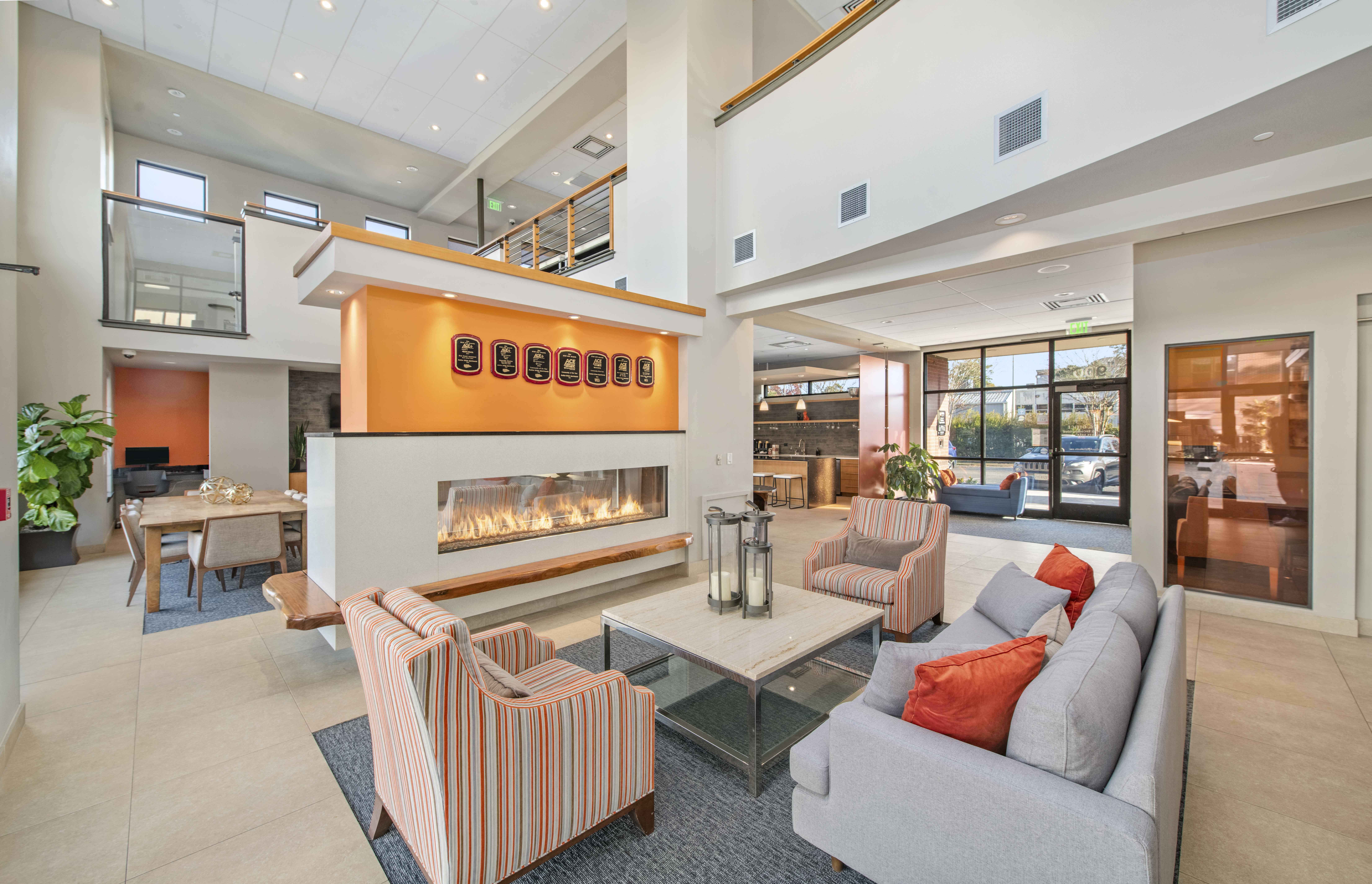 a living room with couches and chairs and a fireplace