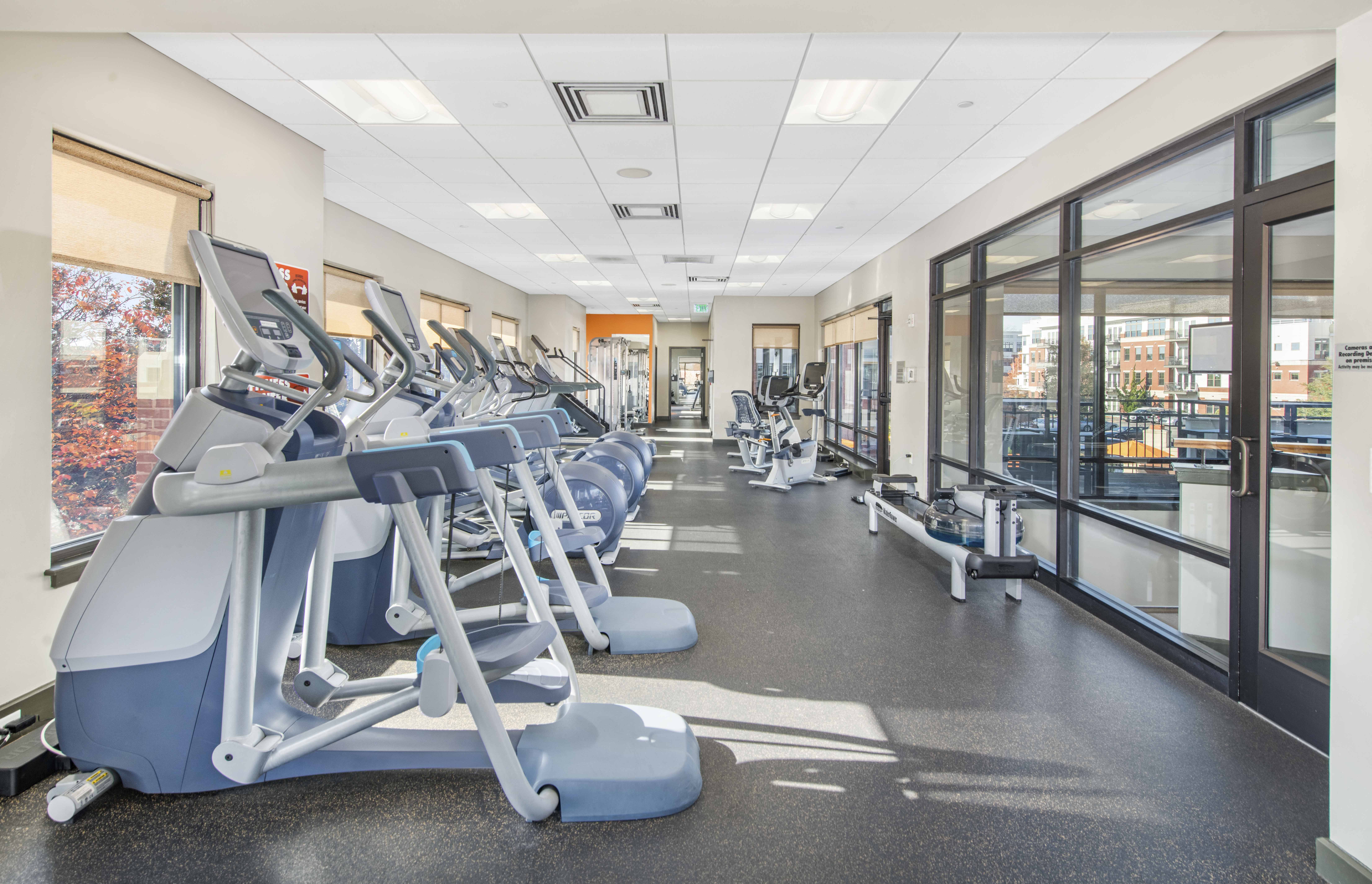 a cardio gym with cardio equipment and windows