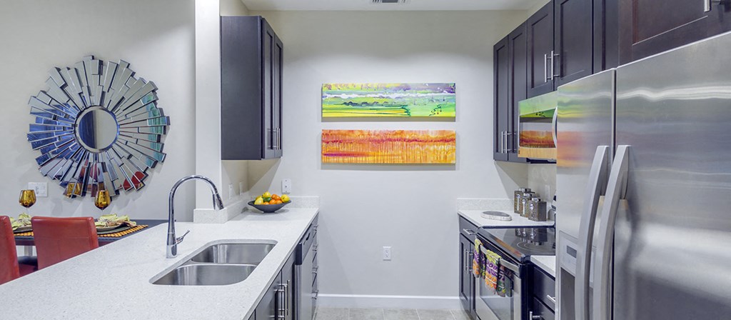 a kitchen with stainless steel appliances and a counter top