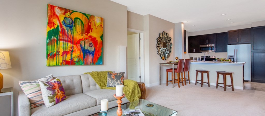 a living room and kitchen with a couch and a table