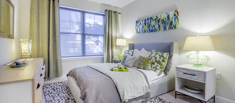 a bedroom with a bed and a window