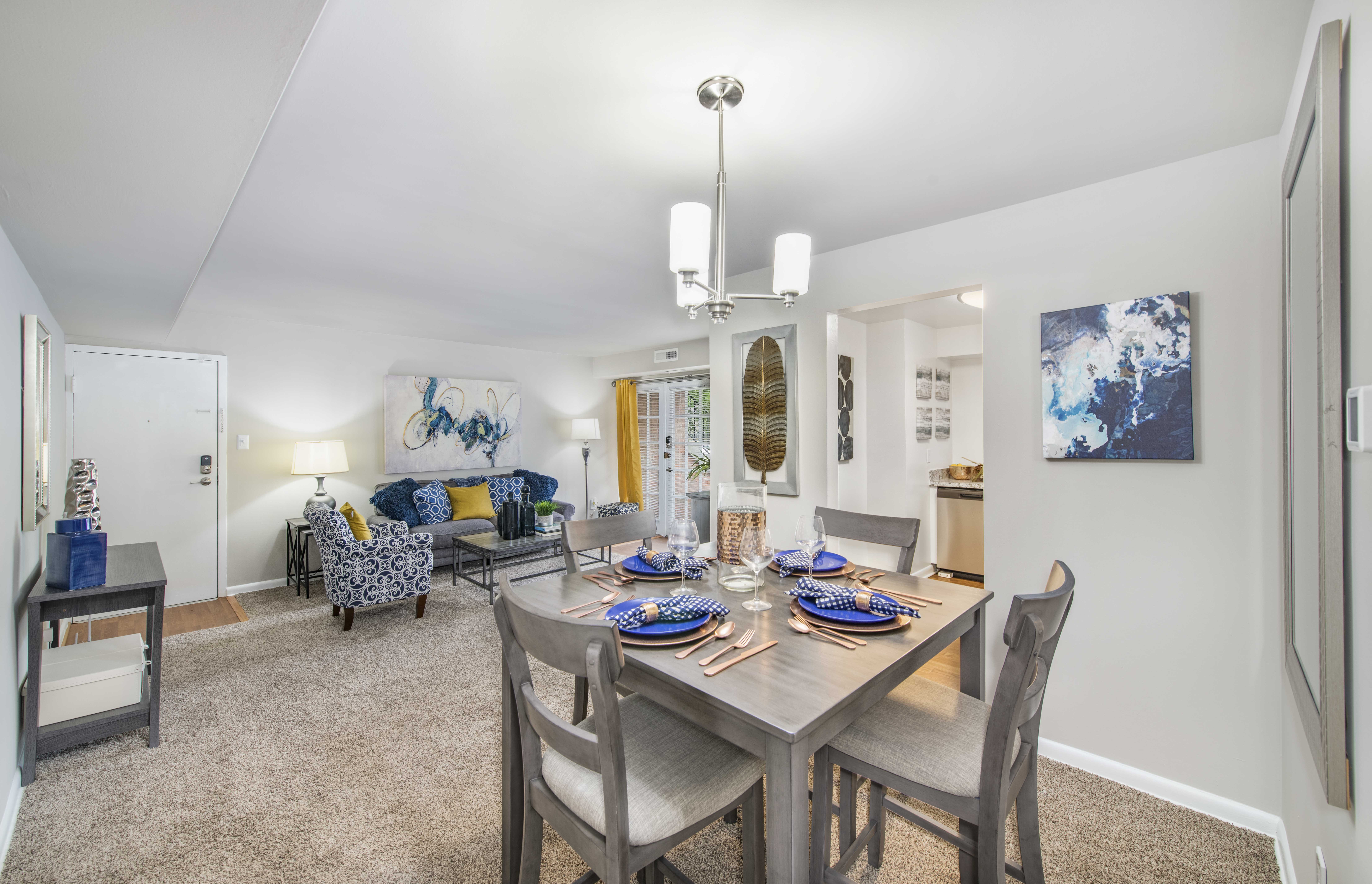 A dining room with a table set for a meal.