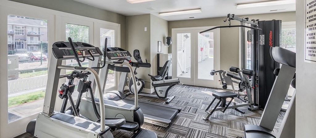 the residence apartments fitness room with exercise equipment