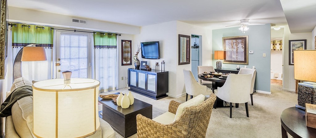 a living room and dining room with furniture and a television