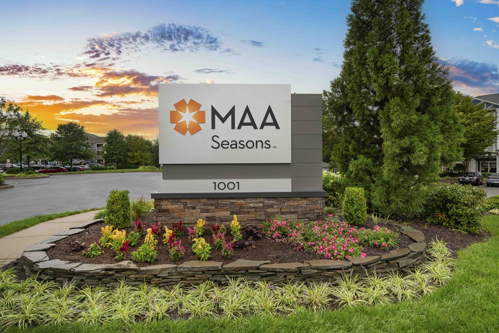 A sign for MAA Seasons stands in front of a building.