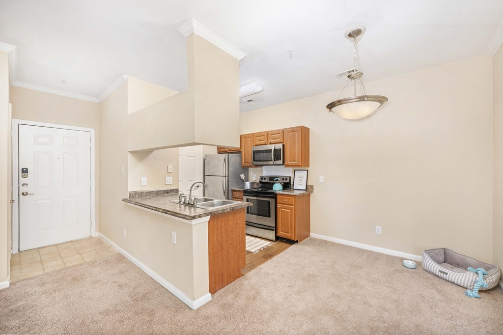 an empty kitchen with a counter top and a sink