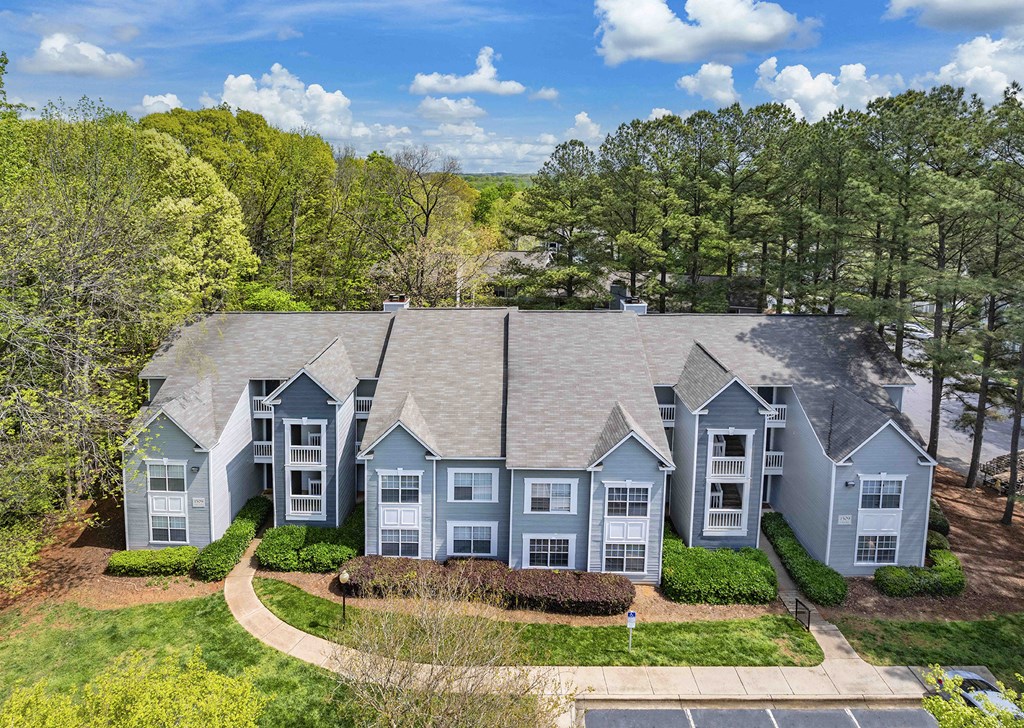 an aerial view of a house with blue trim and a gray roof