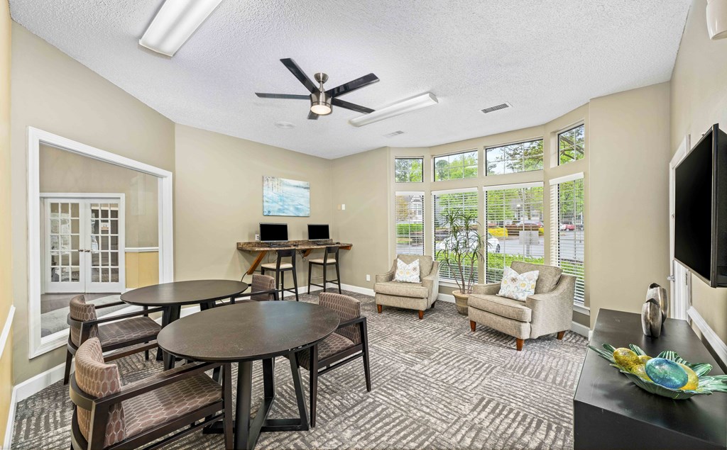 a living room with a table and chairs and a television