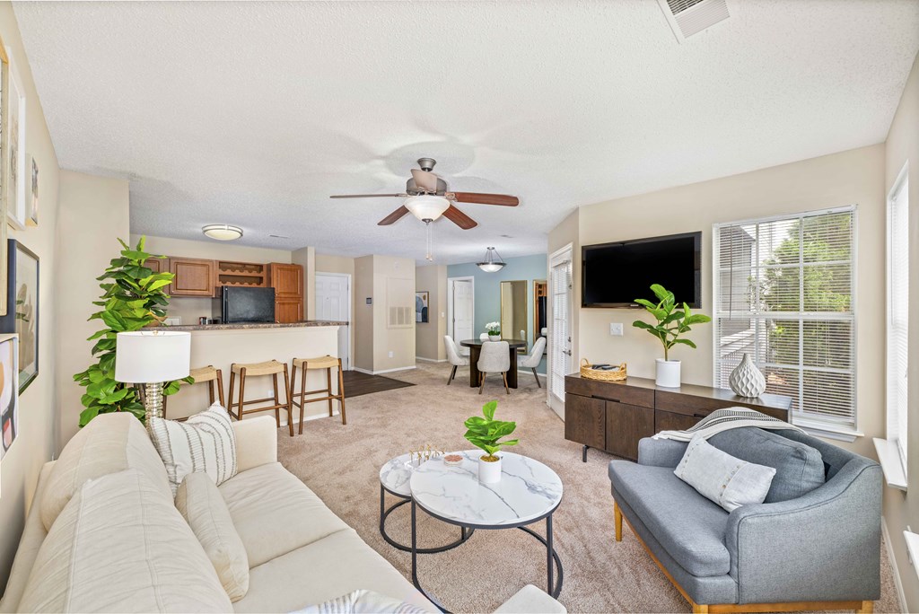 a living room with a couch and a ceiling fan