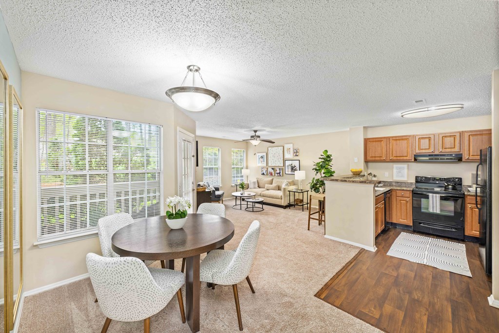 a dining room and kitchen with a table and chairs