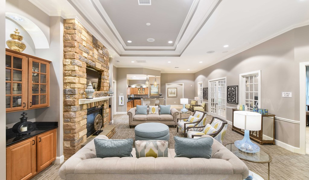 A living room with a stone fireplace and a couch.