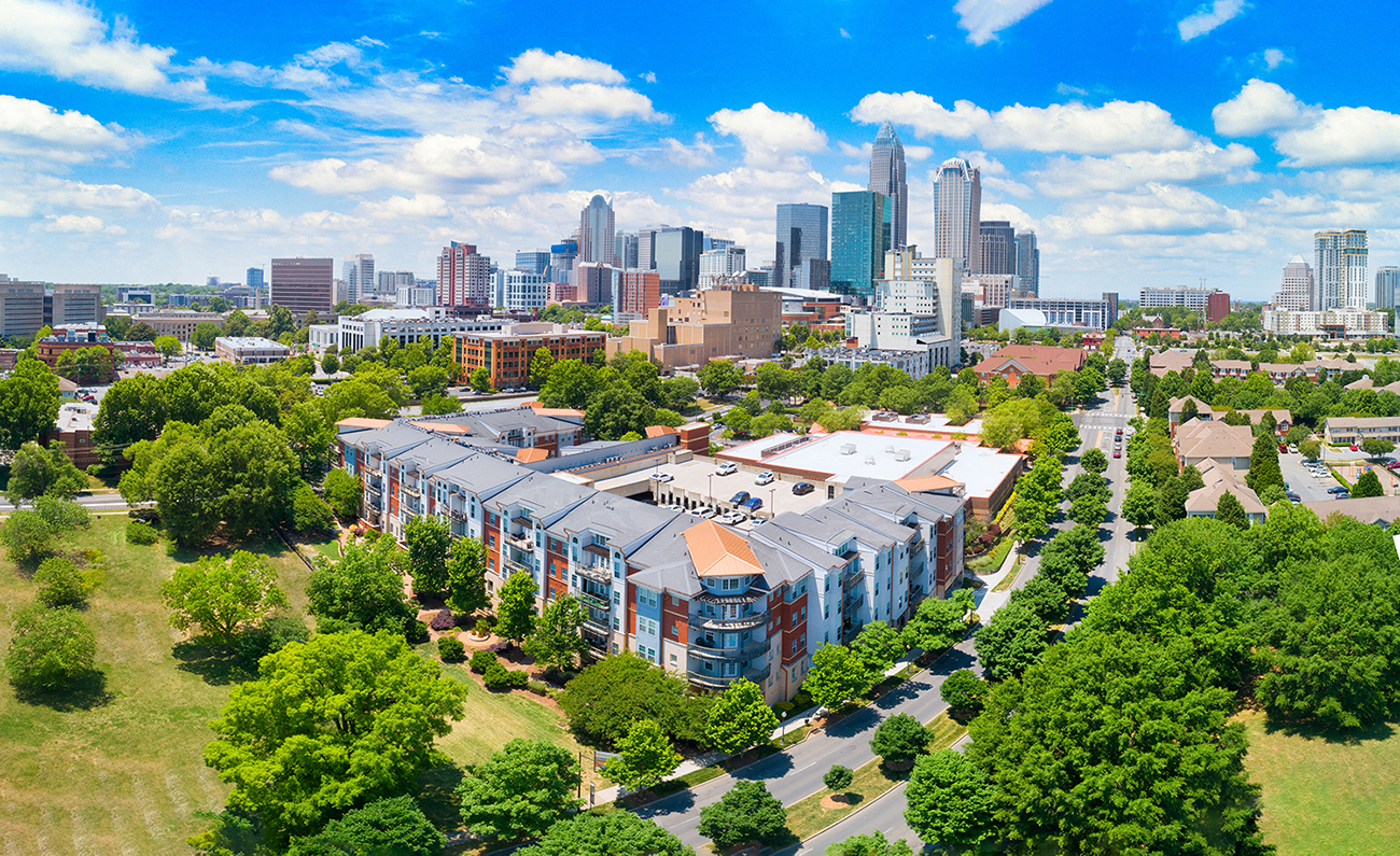 an aerial view of a building with a city in the background