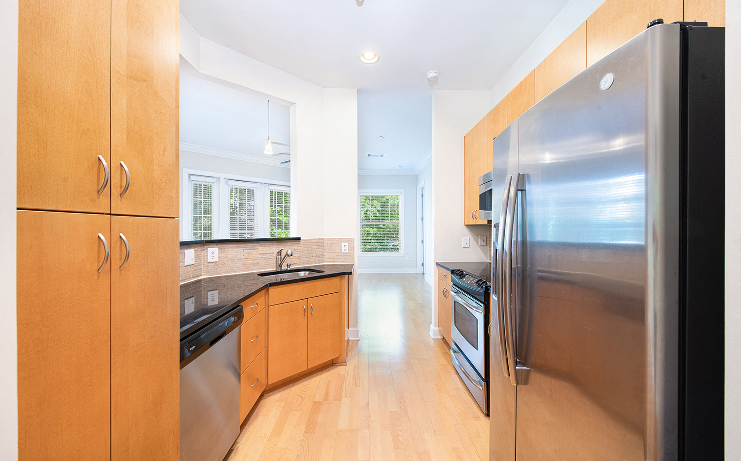 a kitchen with stainless steel appliances and wooden cabinets