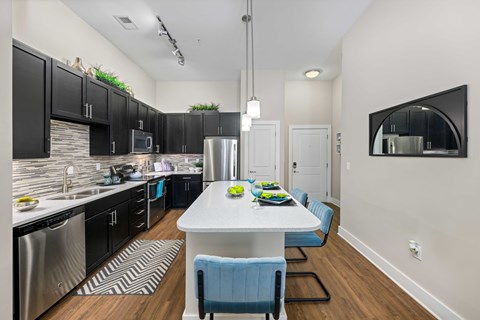 A modern kitchen with a dining table and chairs.