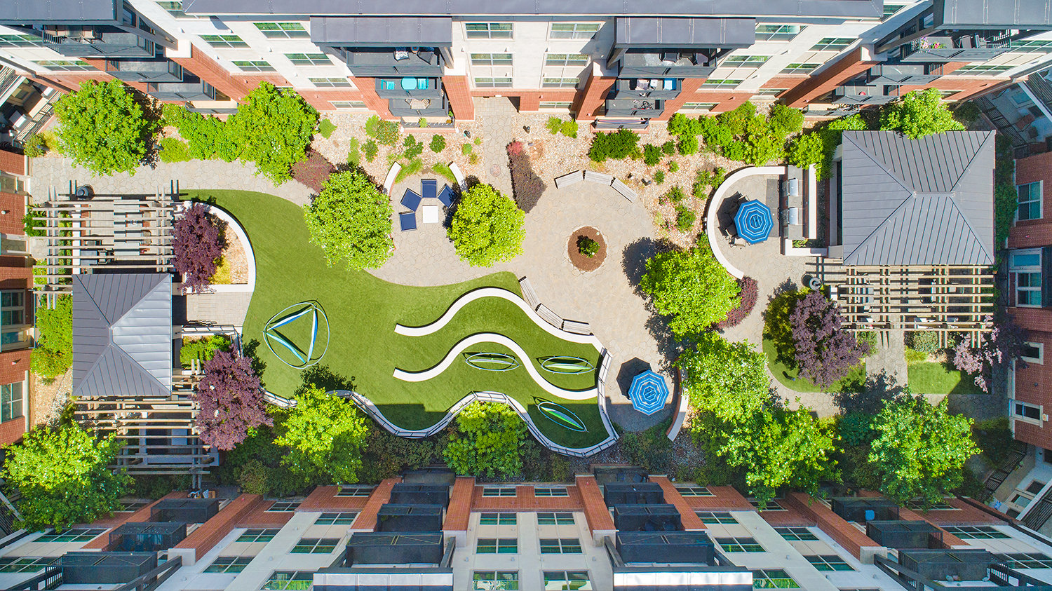 a park in the middle of a city with trees and buildings