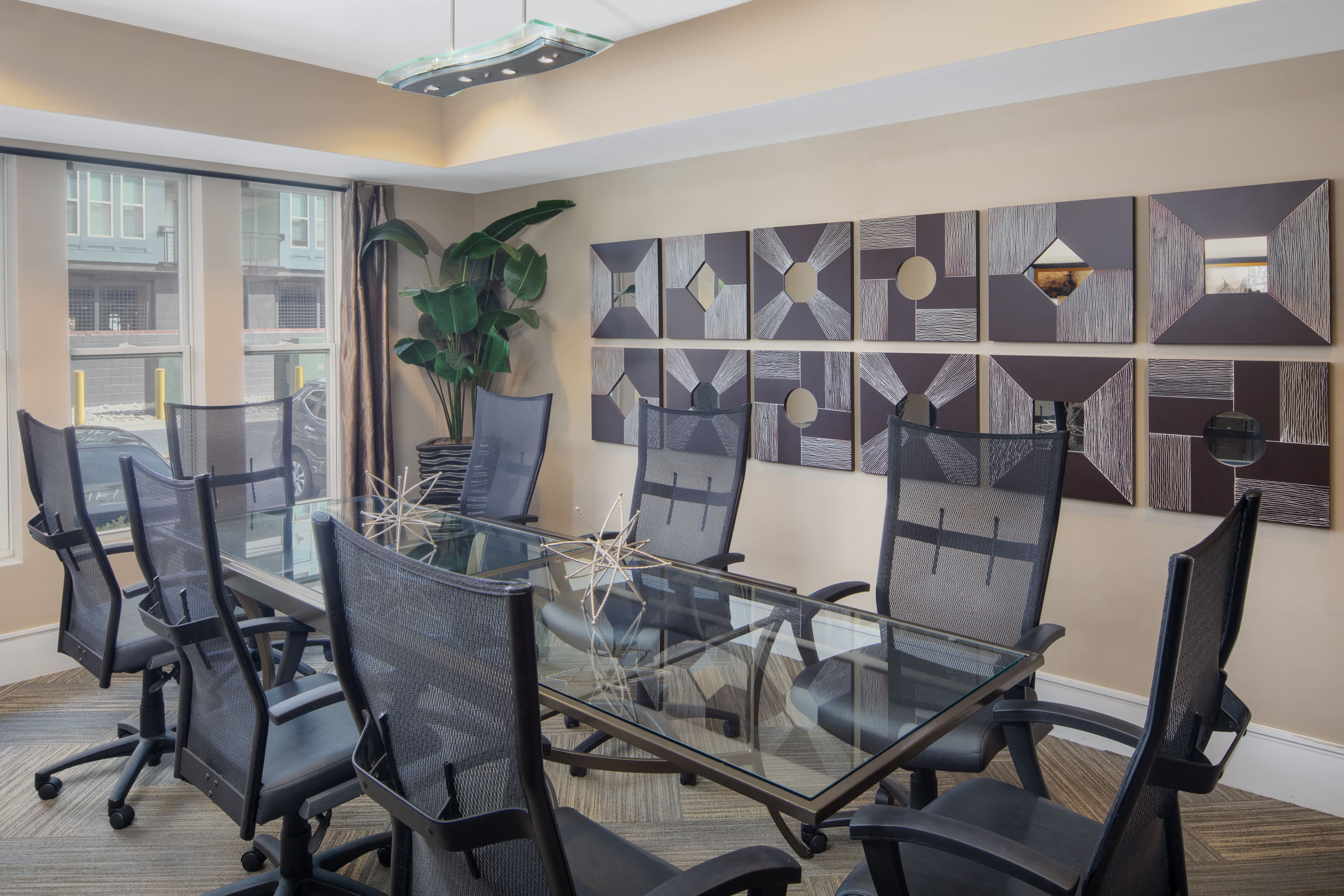 a conference room with a glass table and chairs