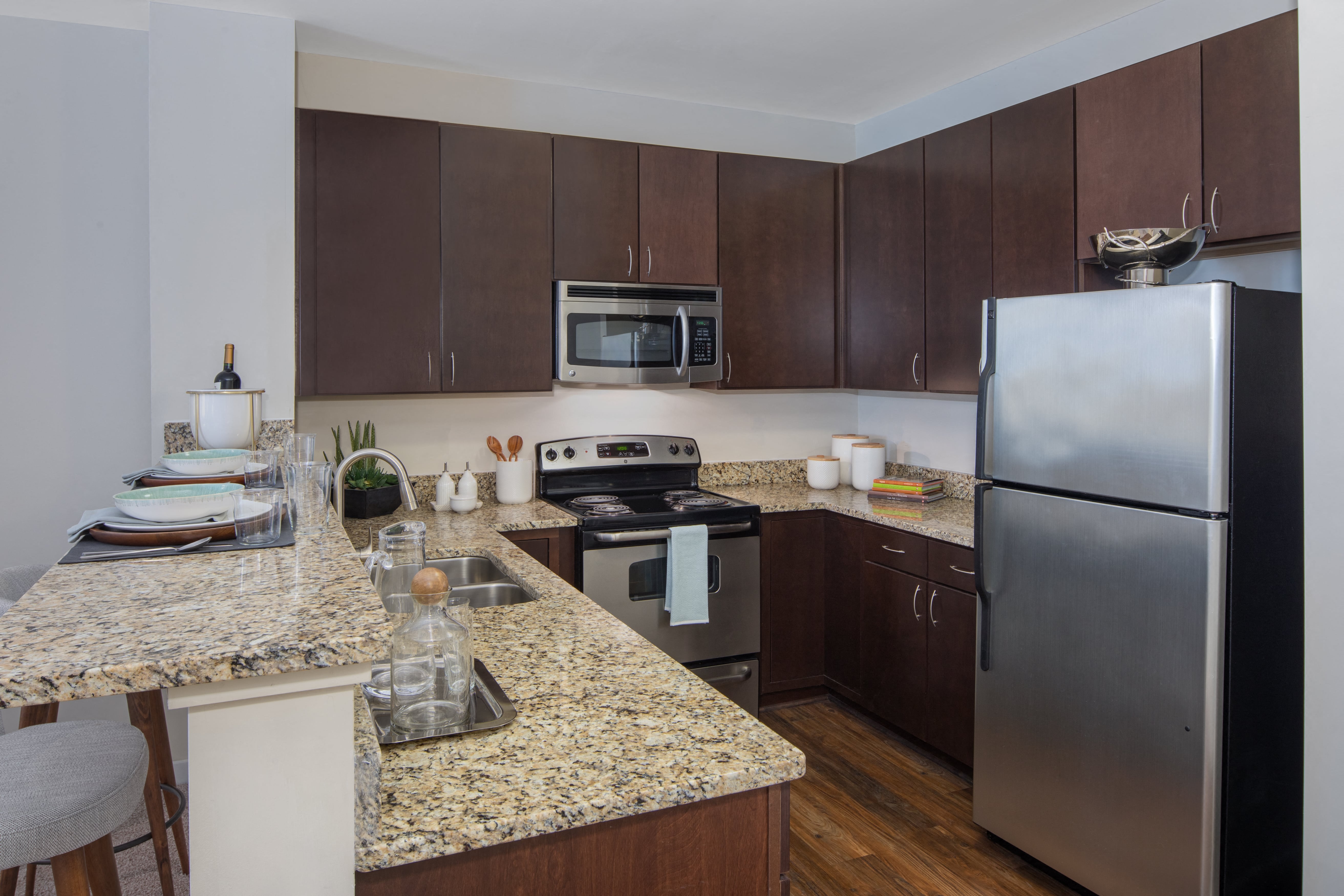 a kitchen with granite counter tops and stainless steel appliances