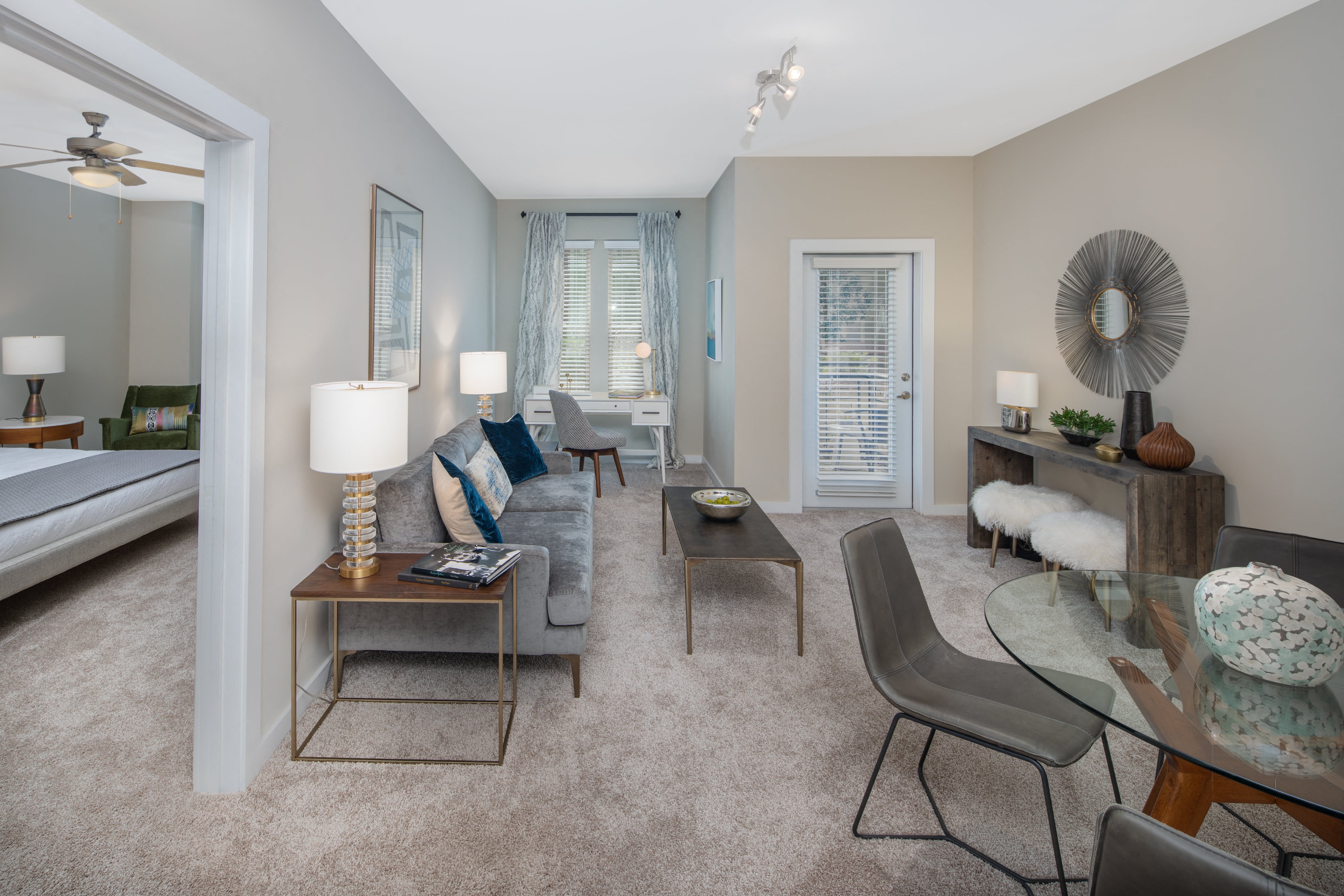 a living room with a couch and chairs and a table