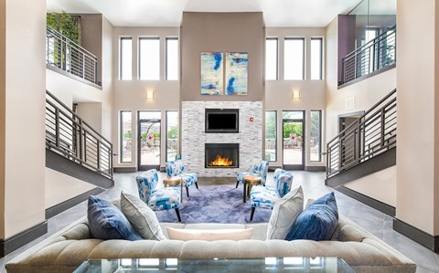 a living room with a couch and chairs and a fireplace
