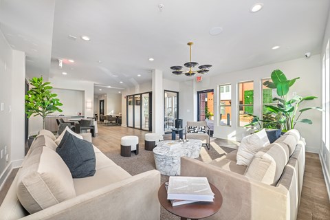 A living room with a beige couch and a coffee table.