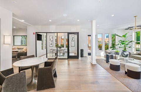 A modern dining room with a long table and chairs.