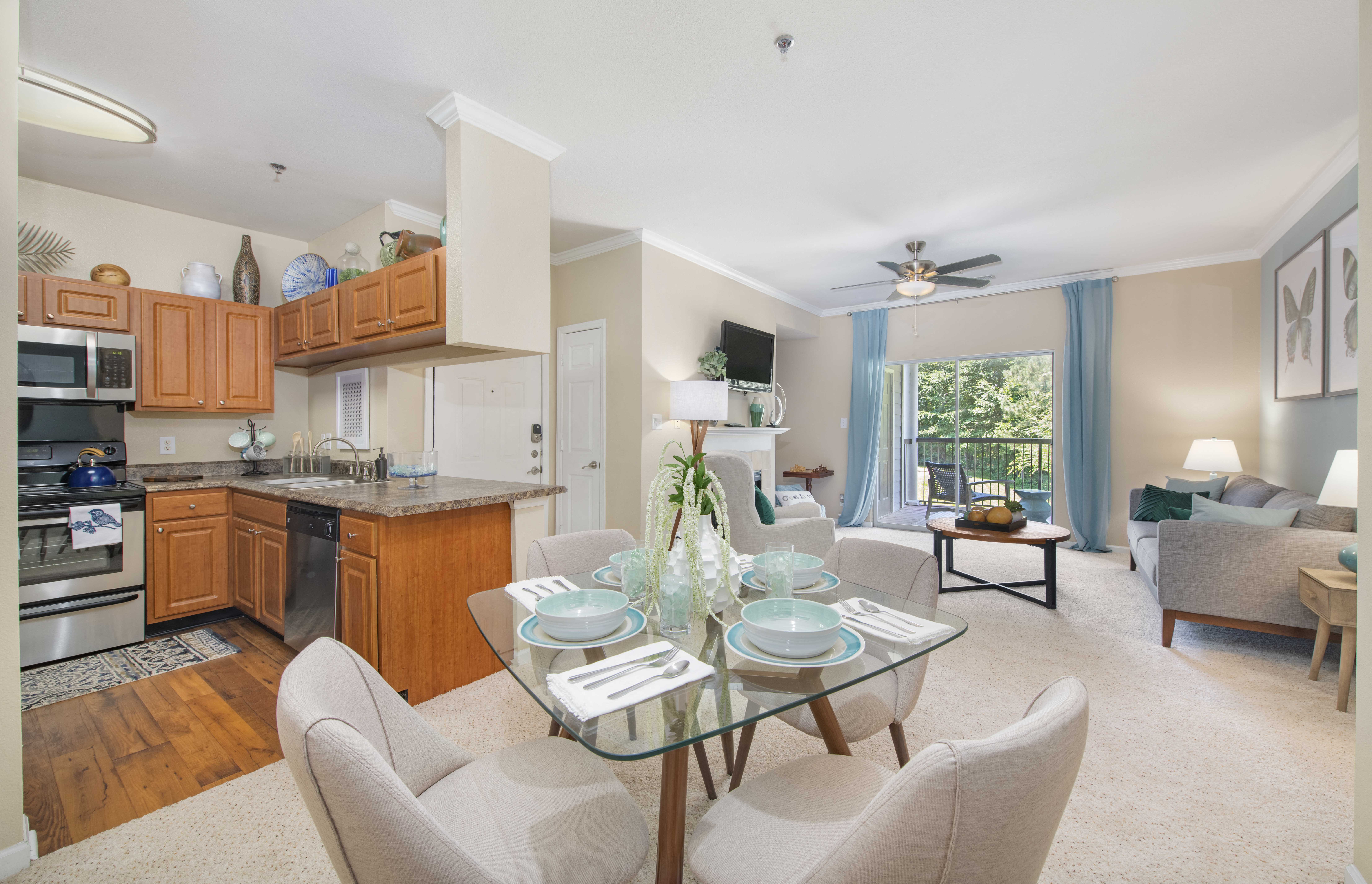 a living room and kitchen with a table and chairs