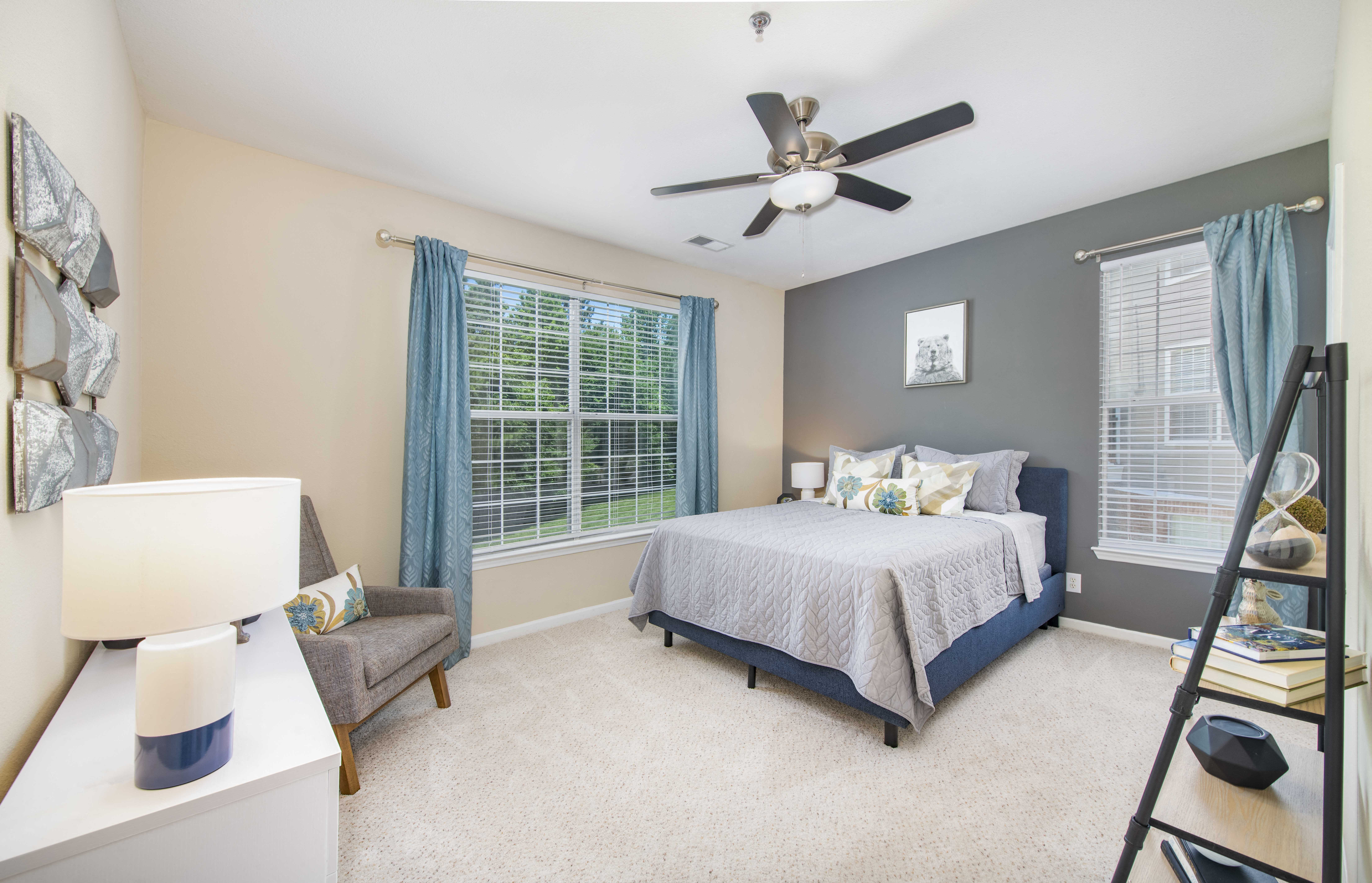 a bedroom with a bed and a ceiling fan