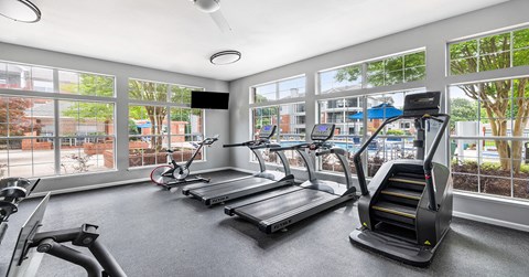 A gym with treadmills, elliptical machines, and a stair climber.