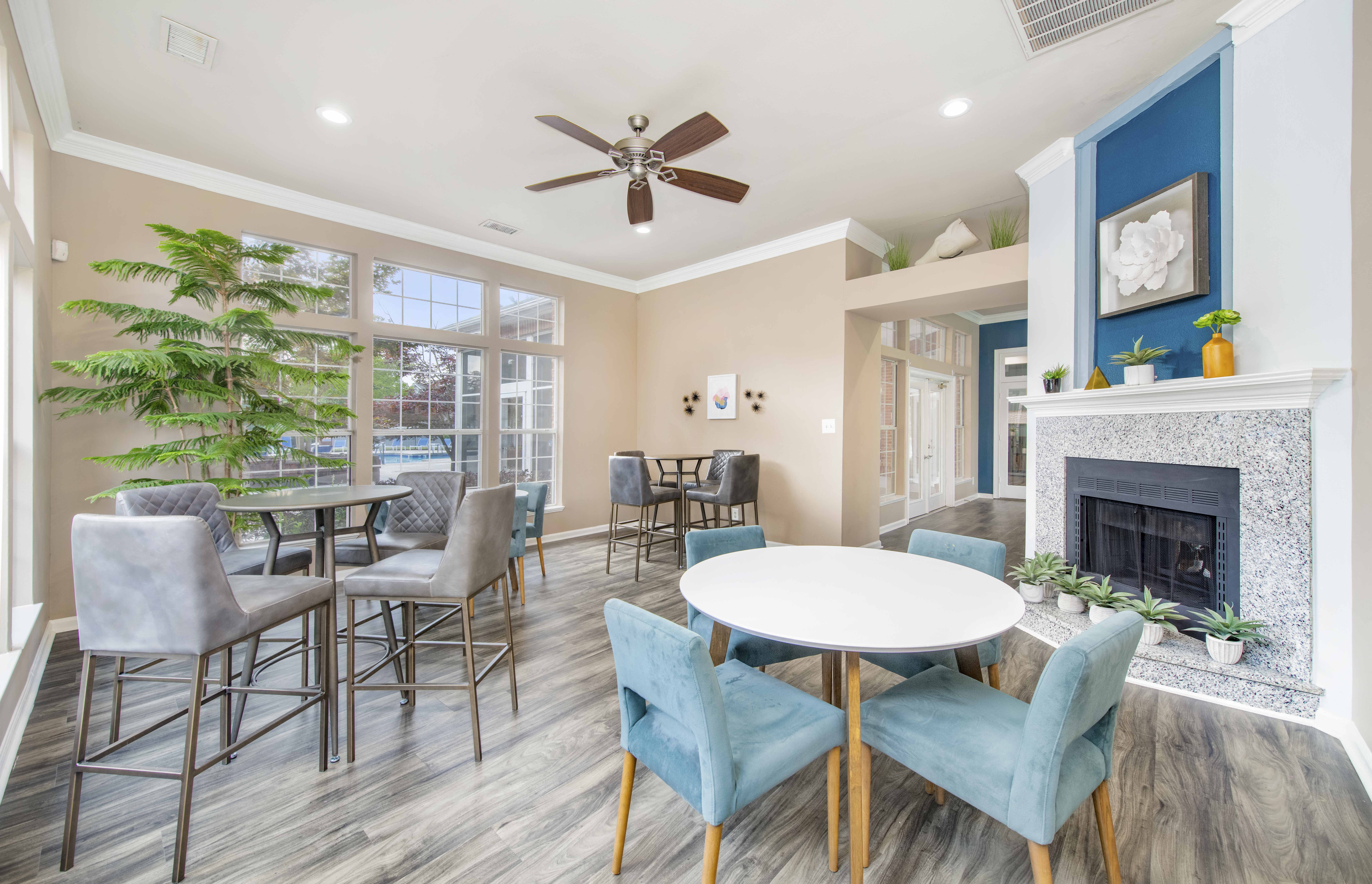 a living room with a fireplace and a table with chairs