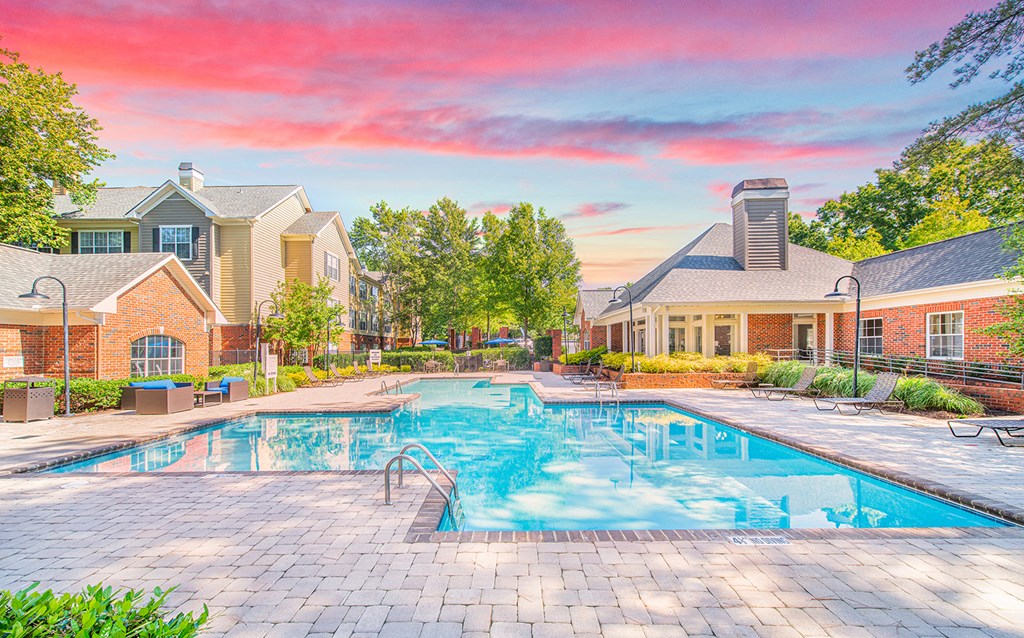 a swimming pool with a house in the background
