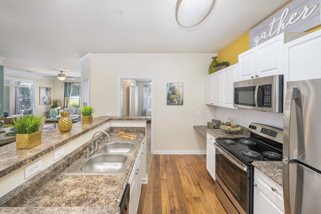 A kitchen with granite countertops and stainless steel appliances.