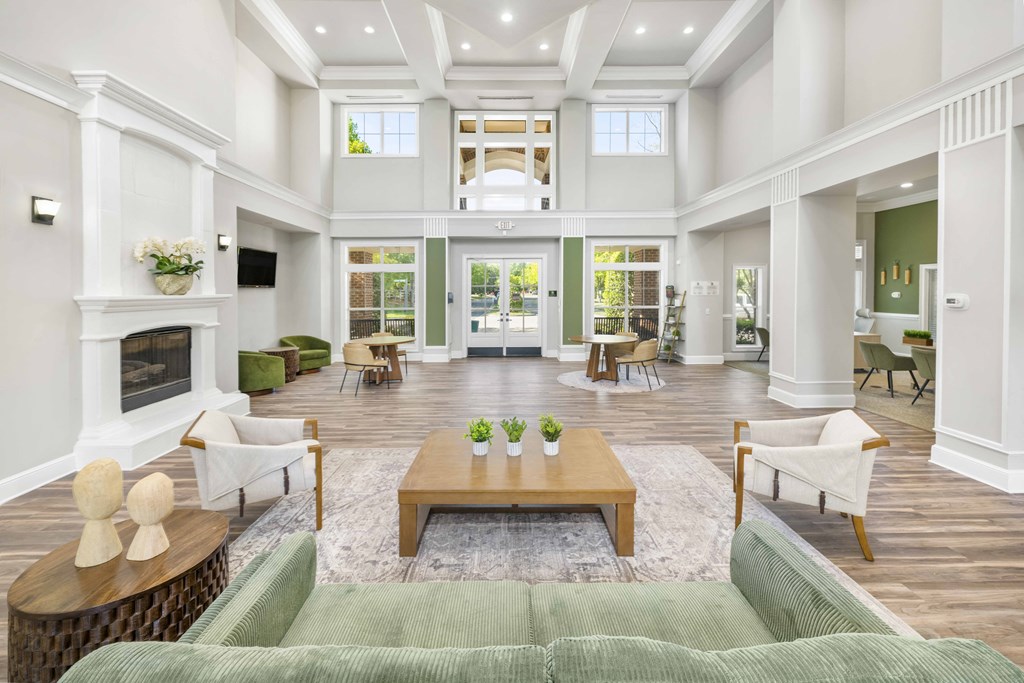 A large, well-lit living room with a fireplace and comfortable seating.
