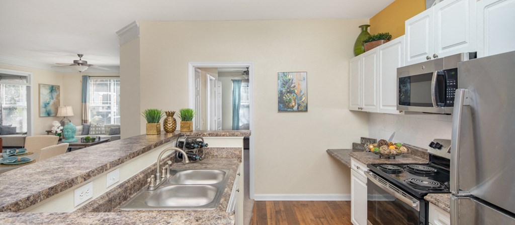 a kitchen with stainless steel appliances and granite counter tops