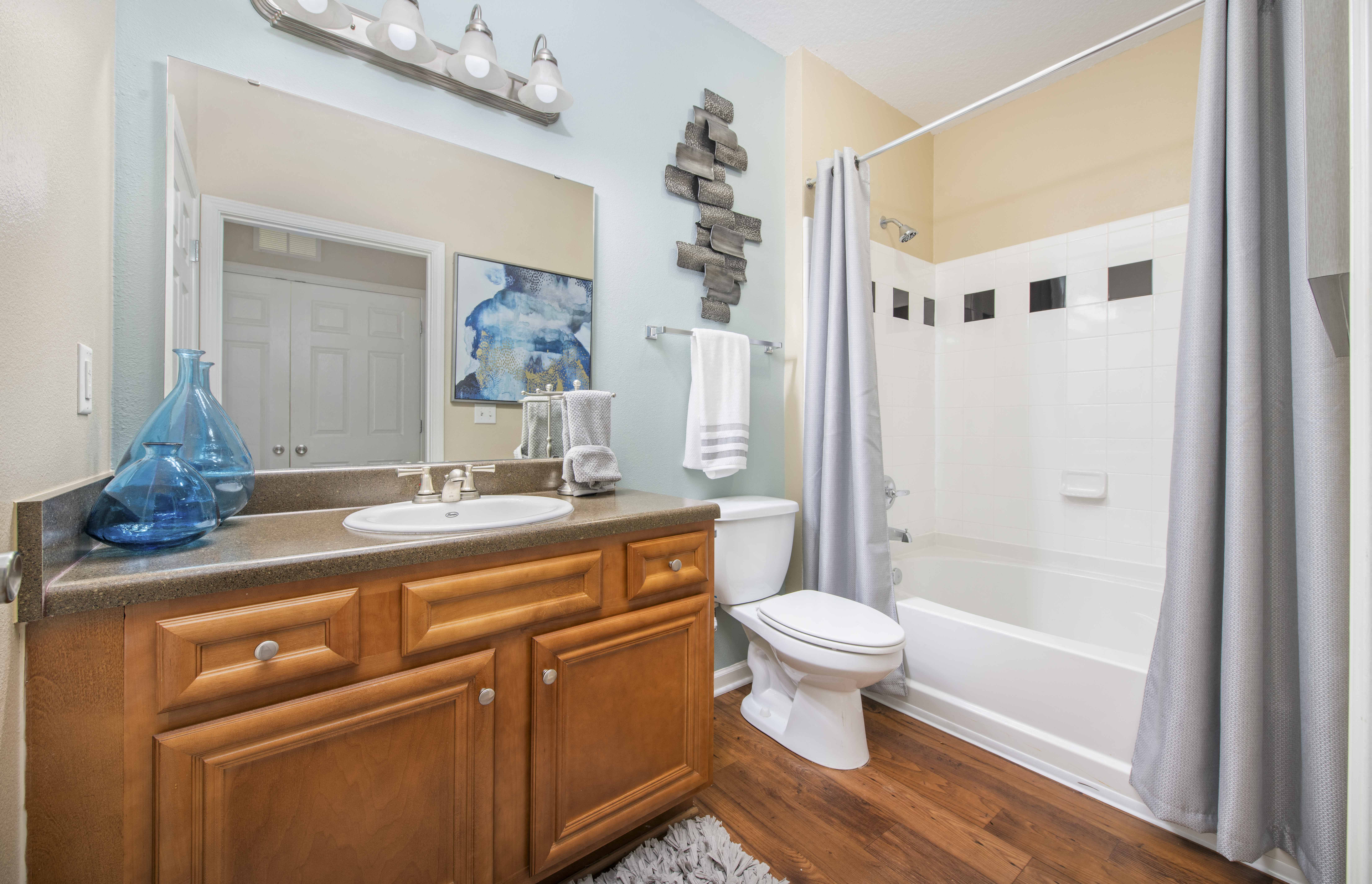 a bathroom with a sink toilet and shower