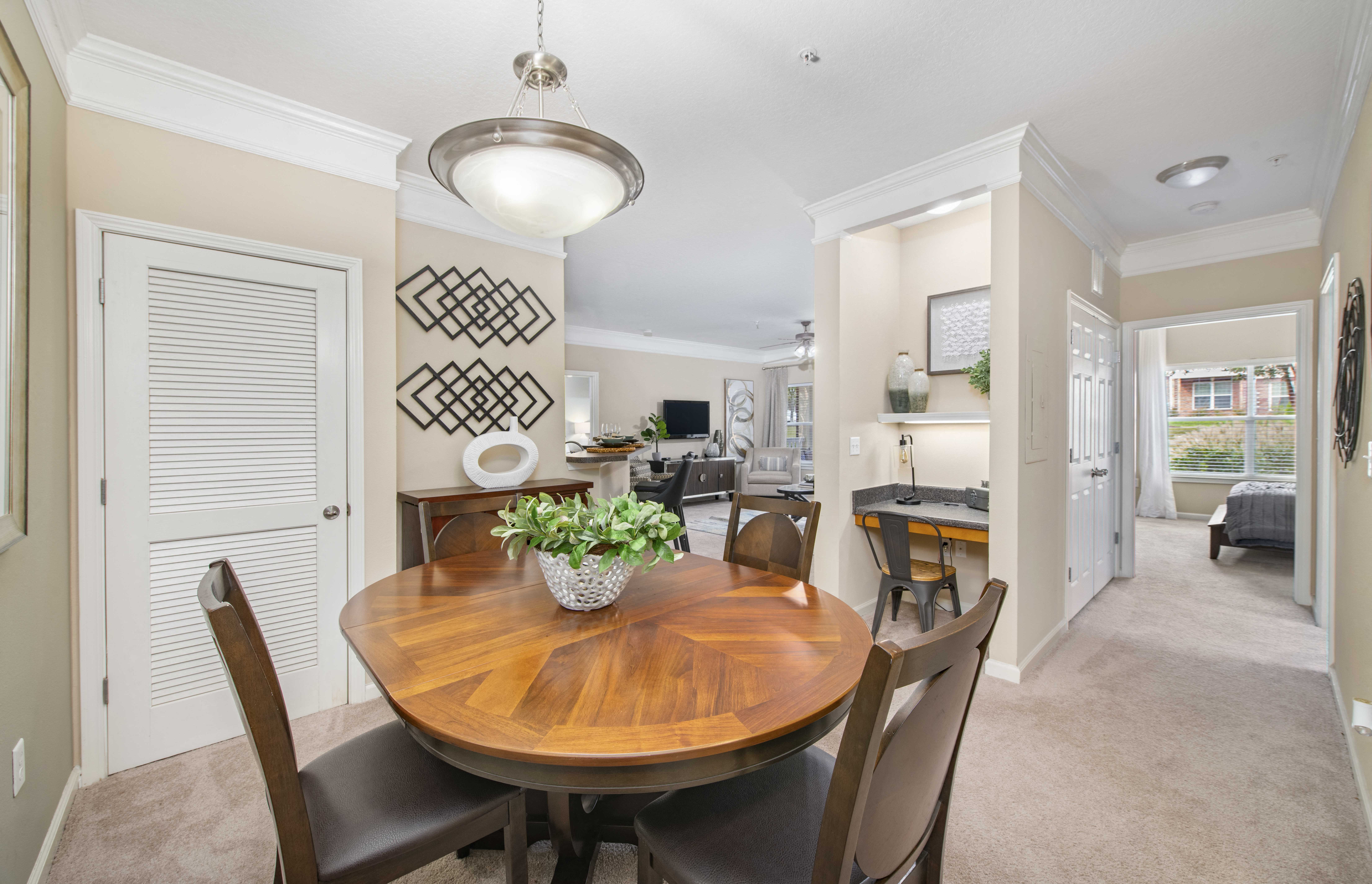 a dining room with a wooden table and chairs