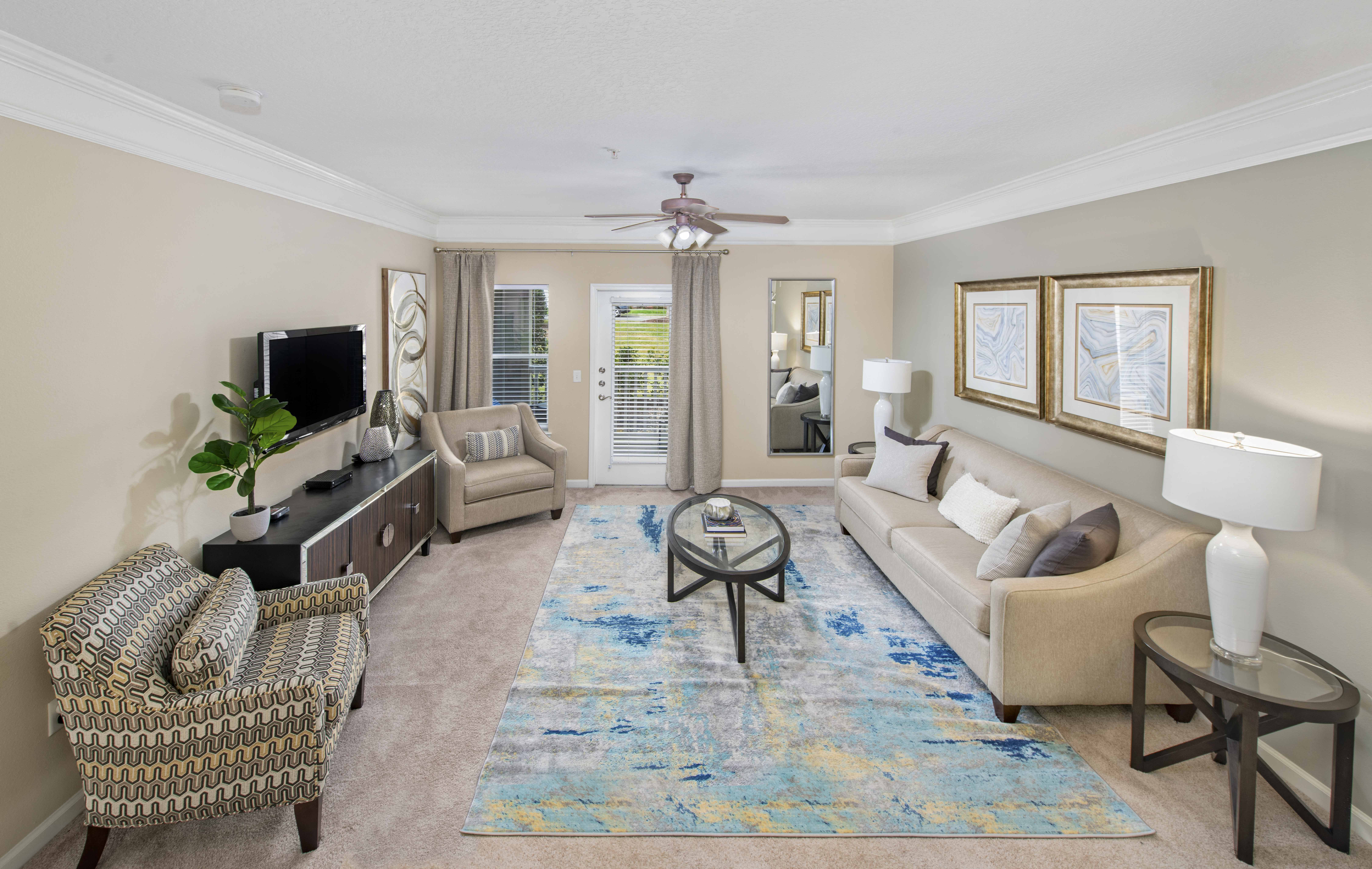 a living room with couches and chairs and a rug
