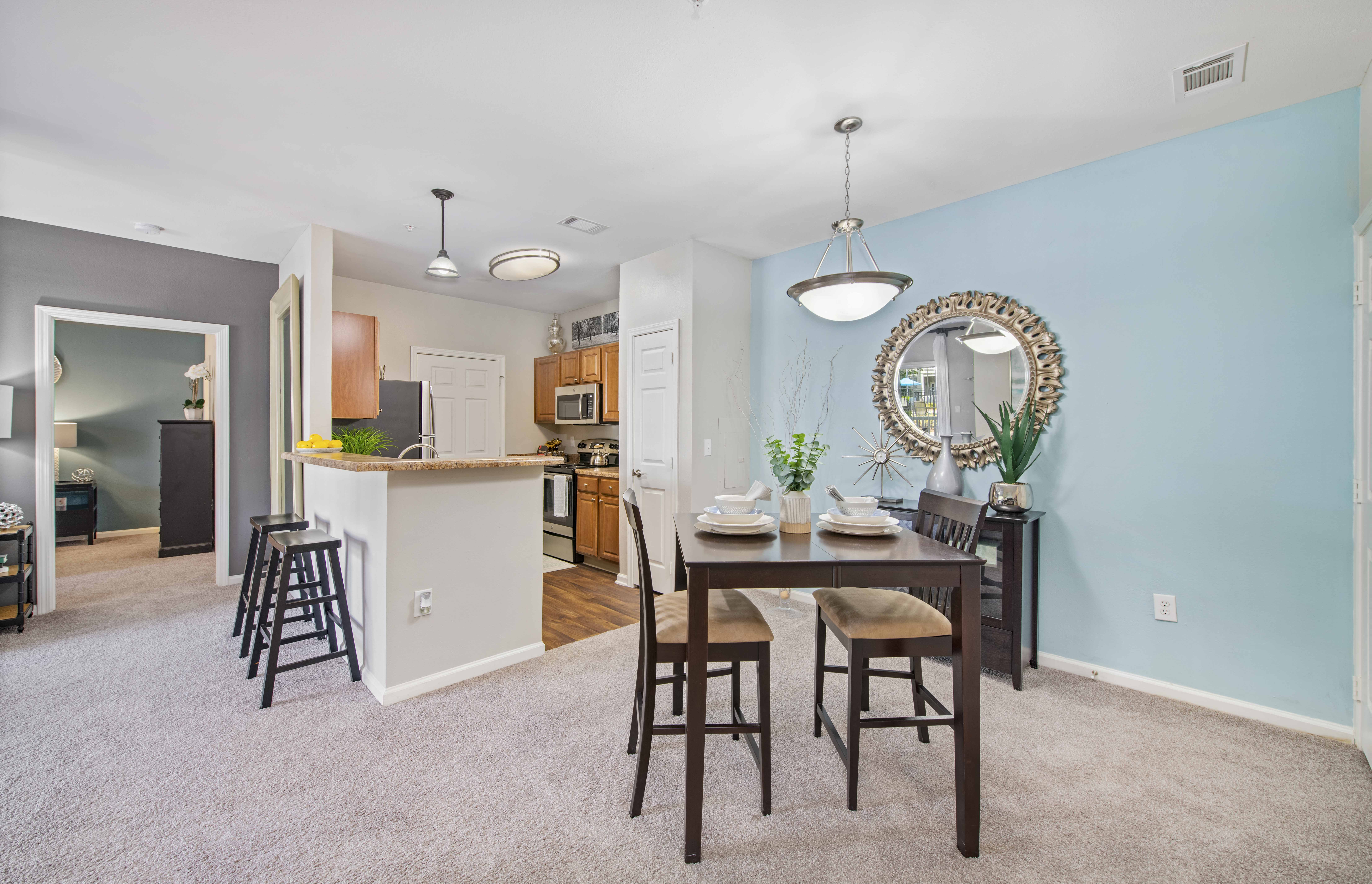 a dining room and kitchen with a table and chairs