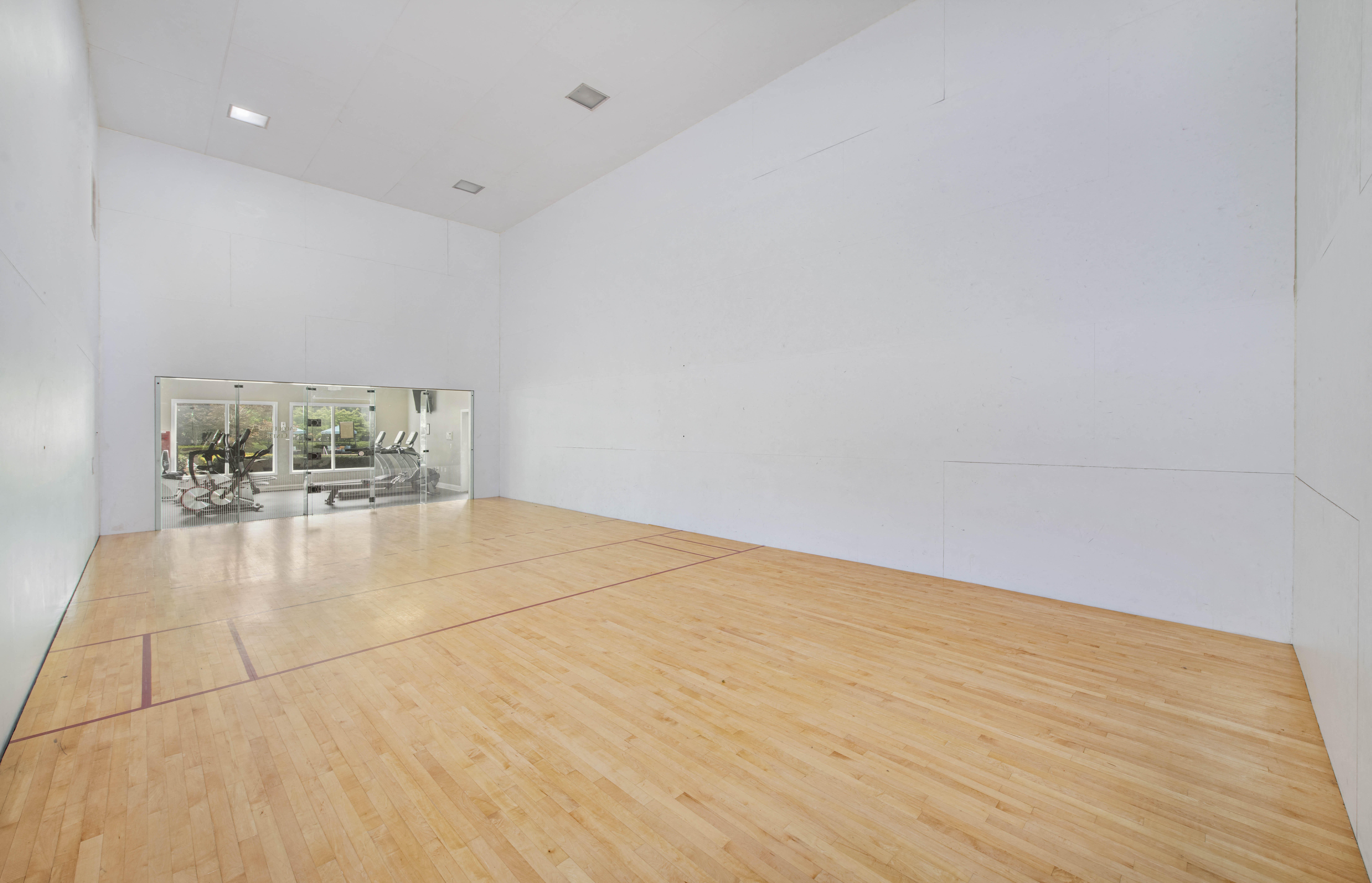 an empty room with a racquetball court and white walls