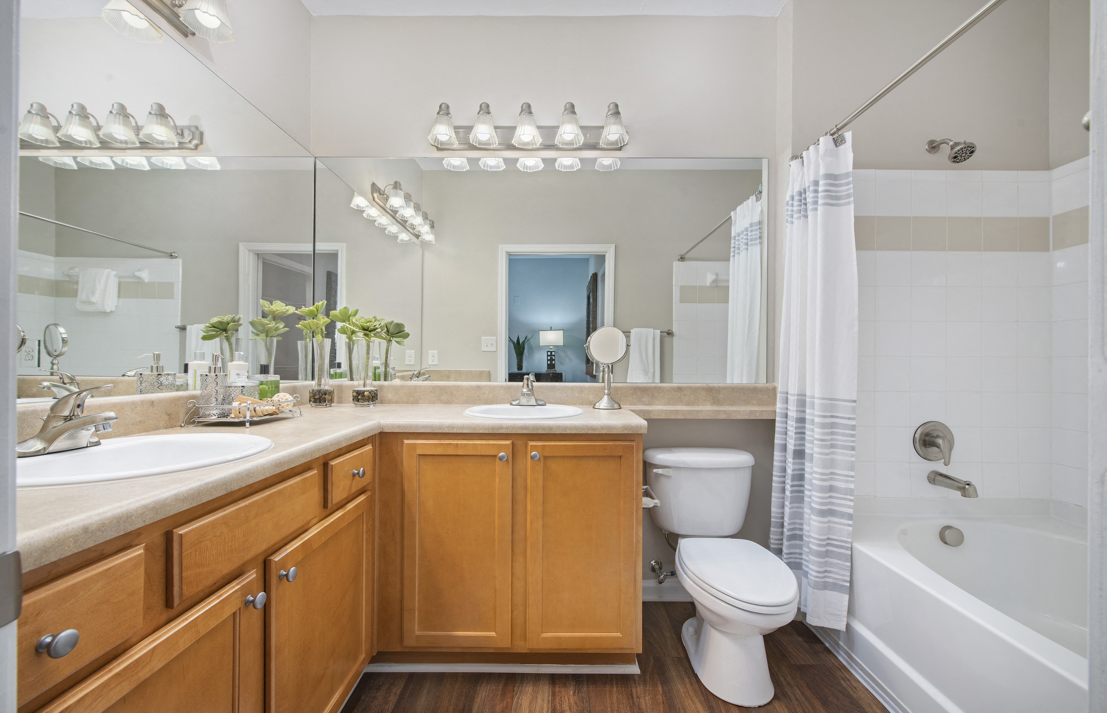 a bathroom with a toilet sink and tub and a mirror