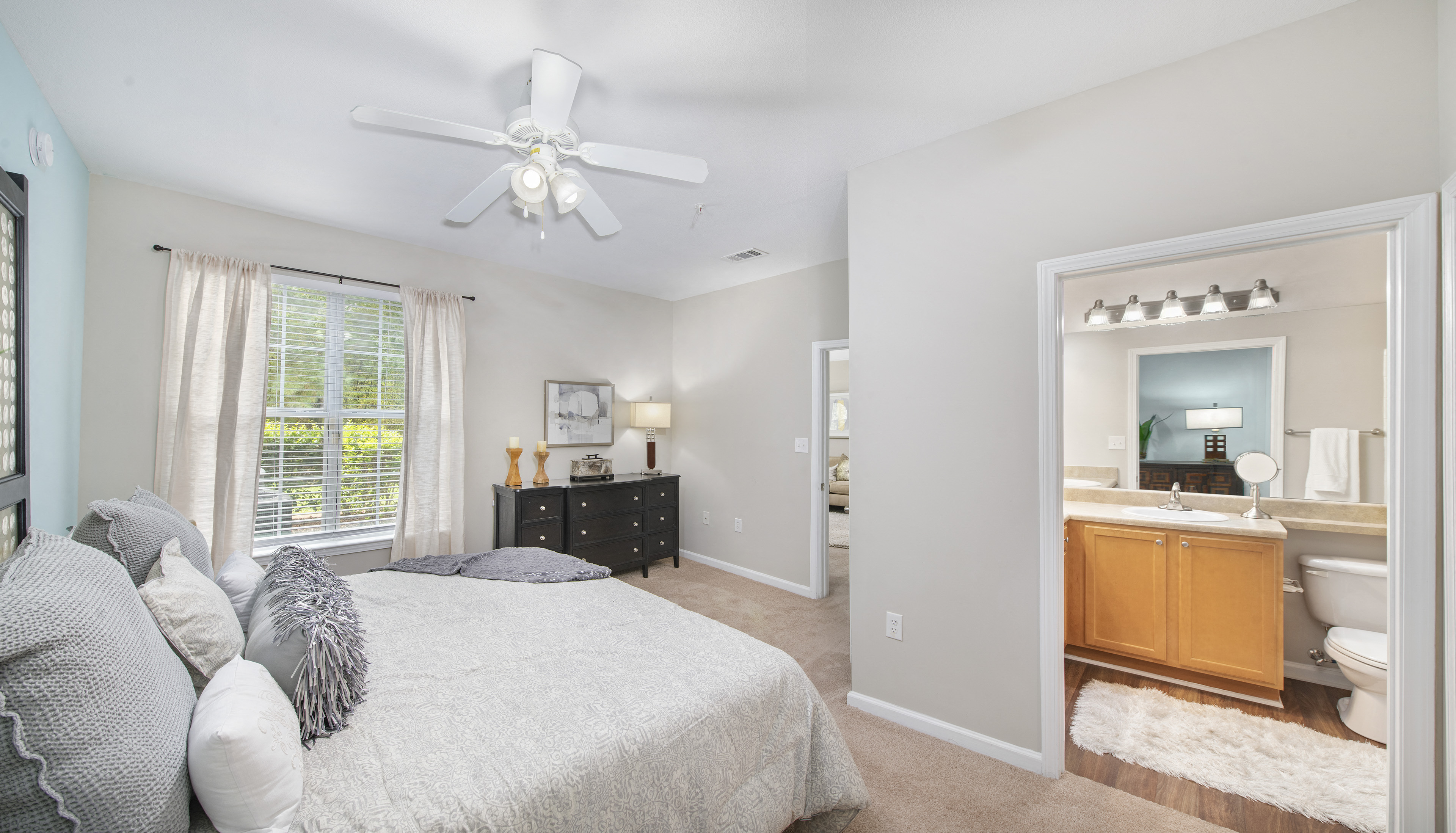 a bedroom with a bed and a ceiling fan