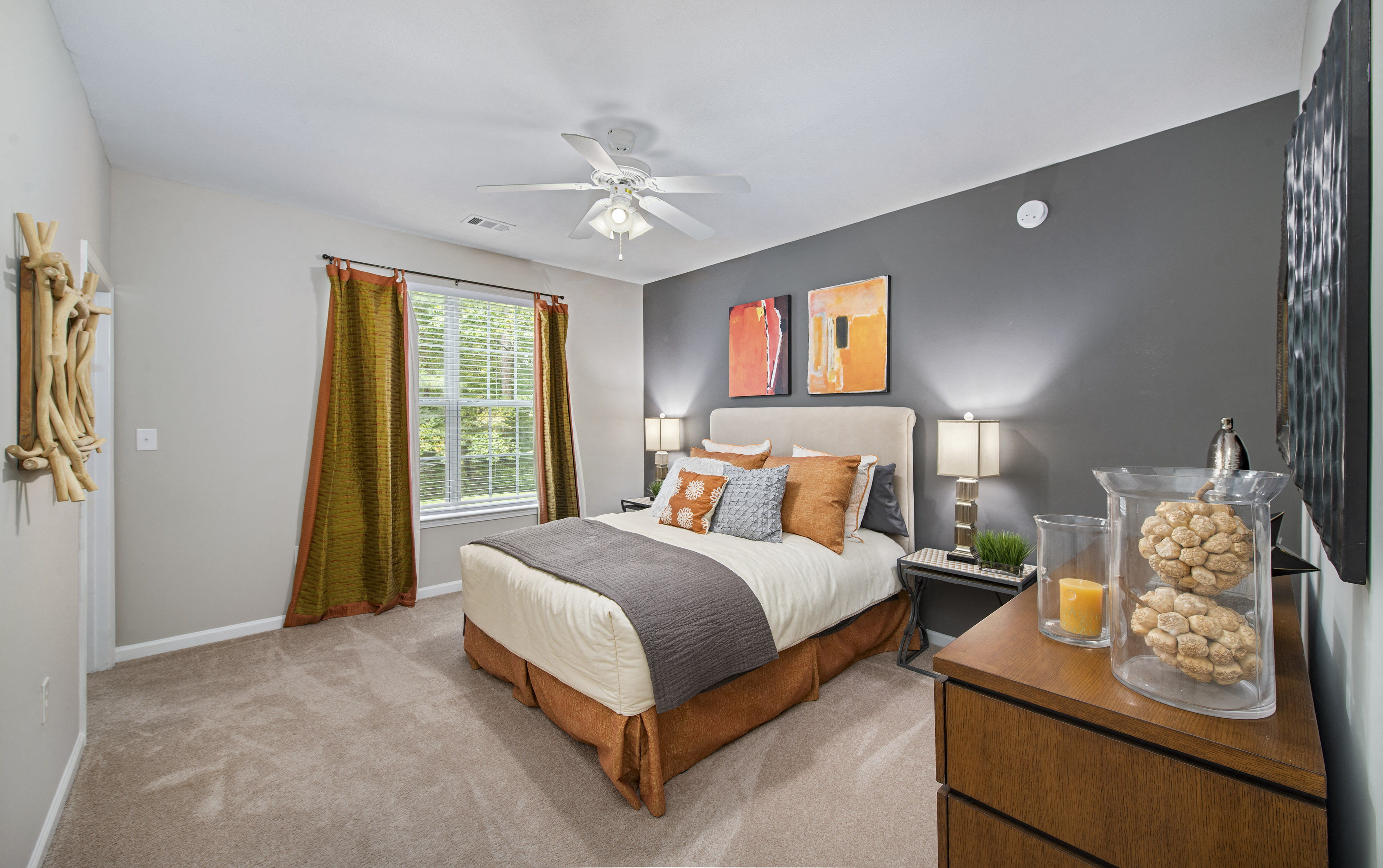 a bedroom with a bed and a ceiling fan