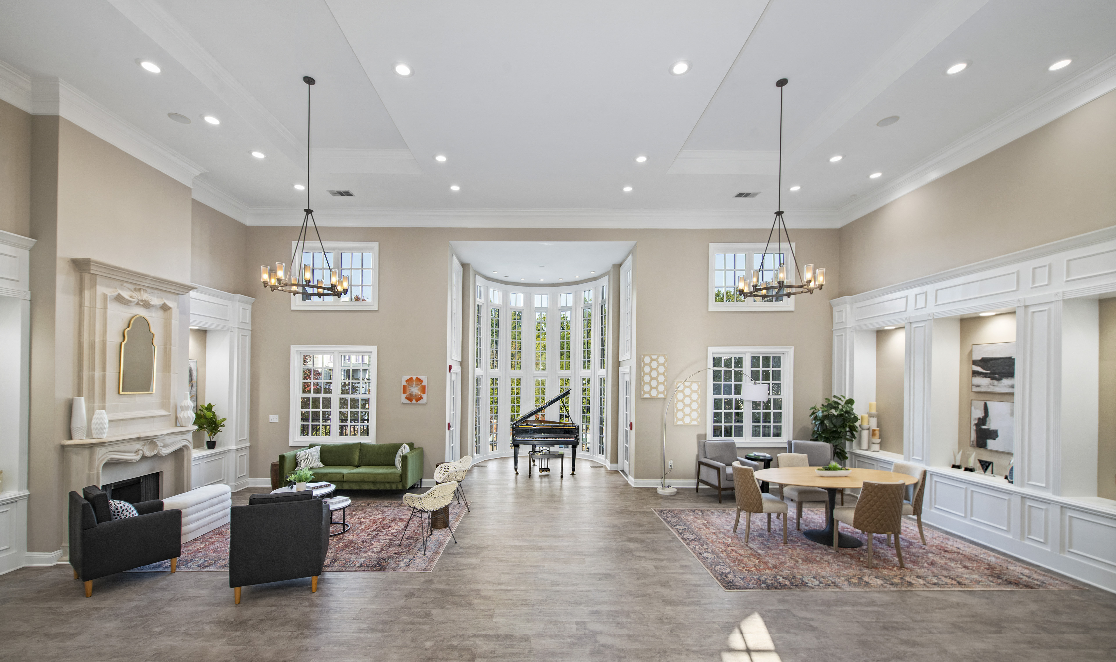 a large living room with a piano in the center of it