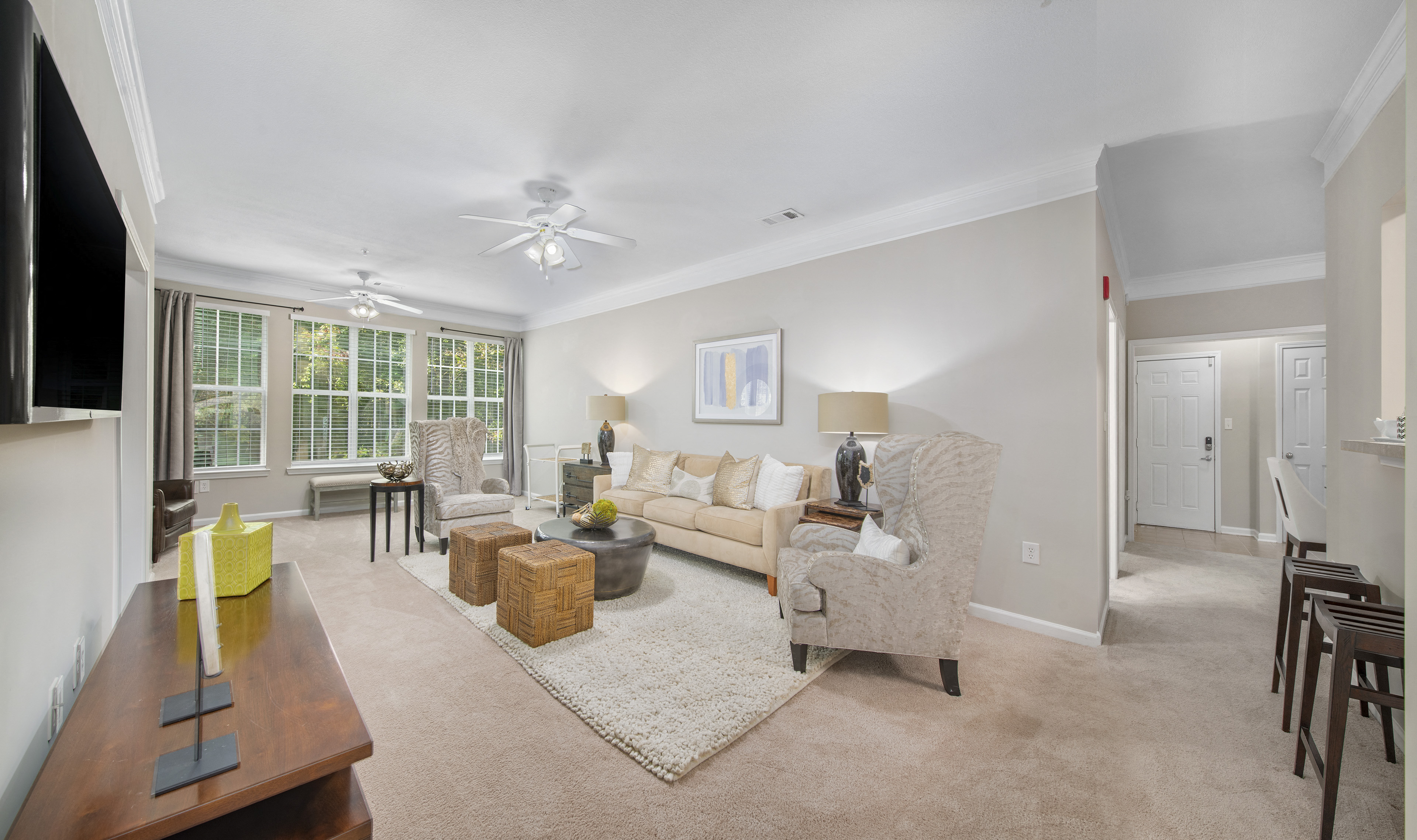 a living room with a couch and chairs and a table