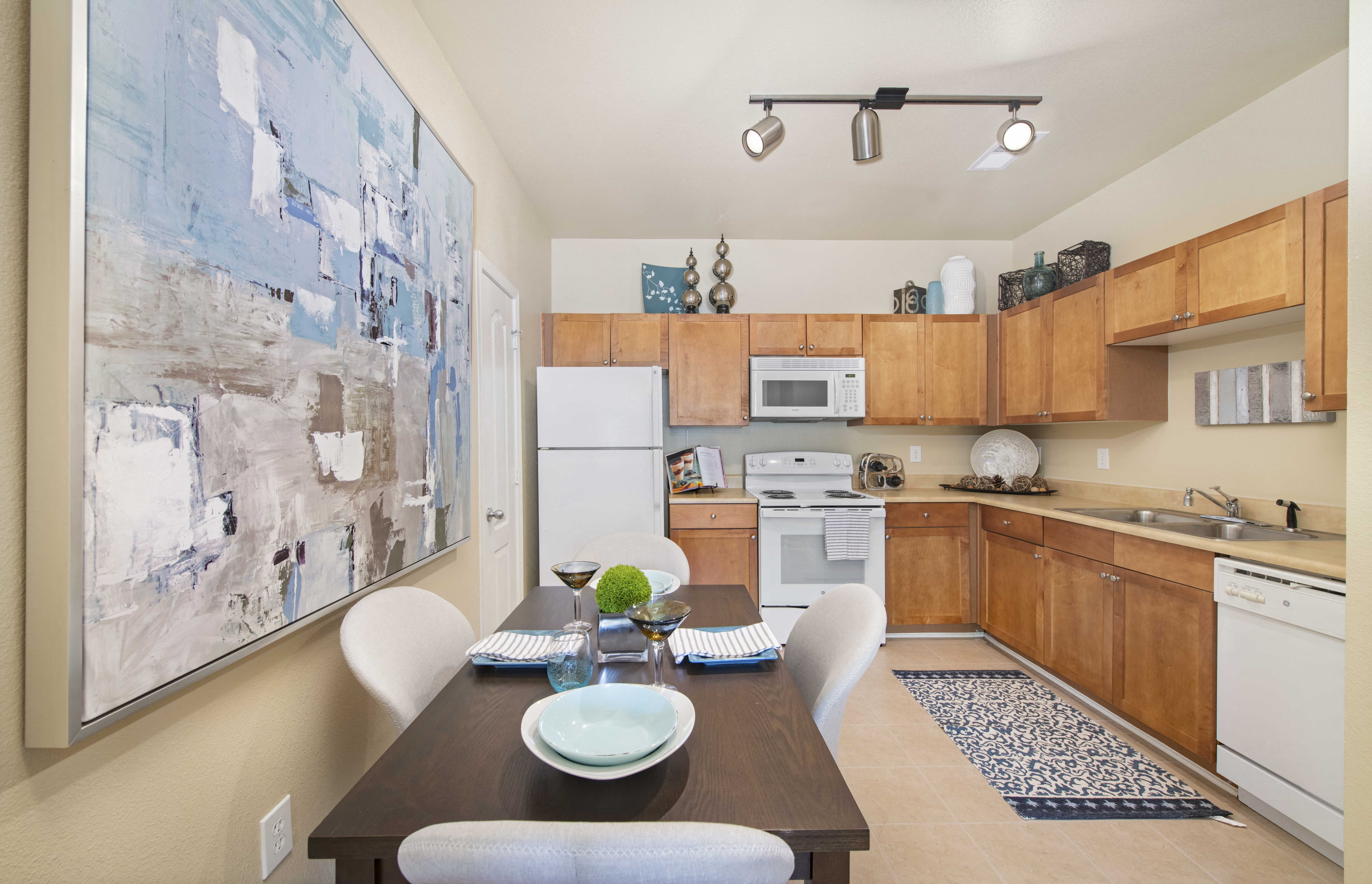 a kitchen and dining room with a table and chairs