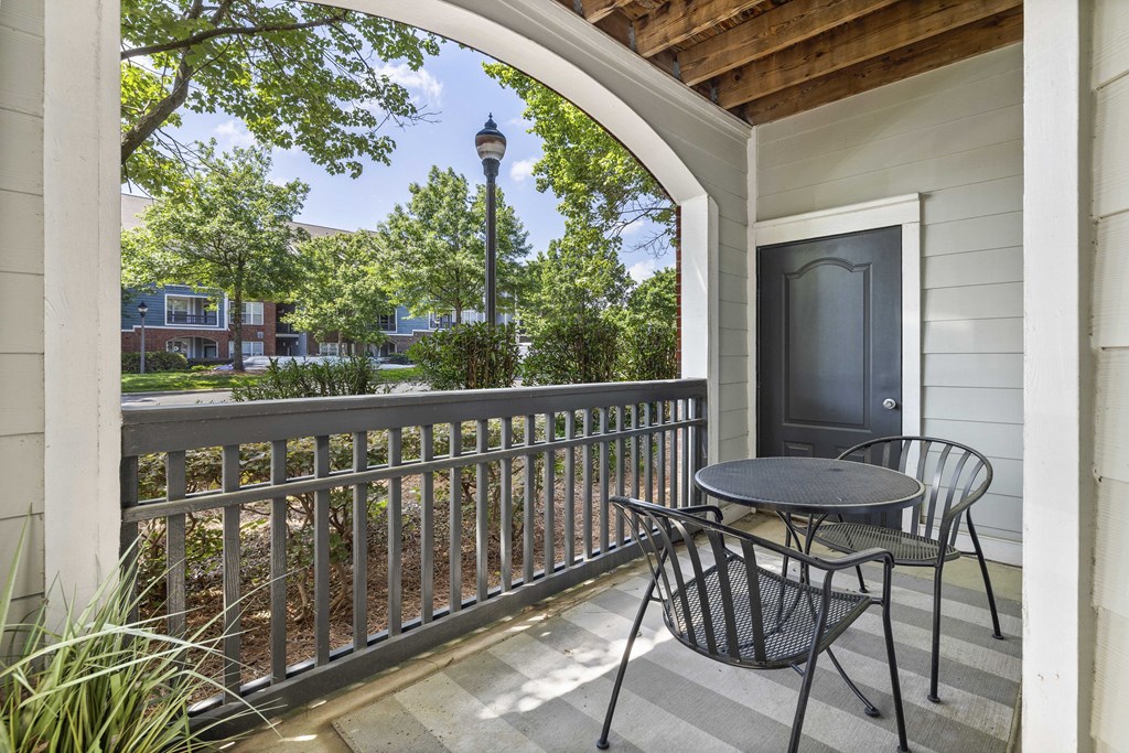 A patio with a table and chairs and a TV.