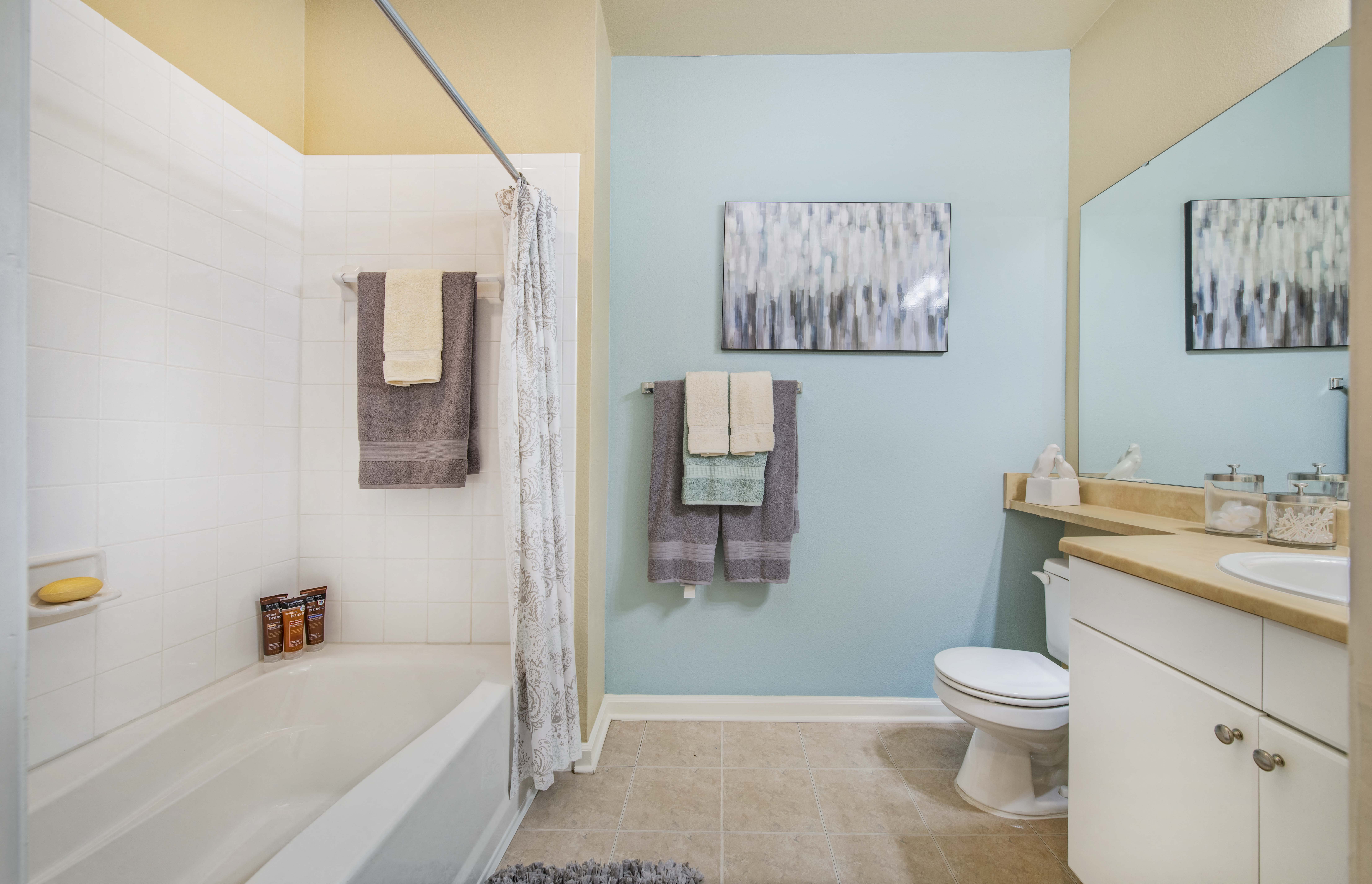 a bathroom with a toilet and a tub and a sink
