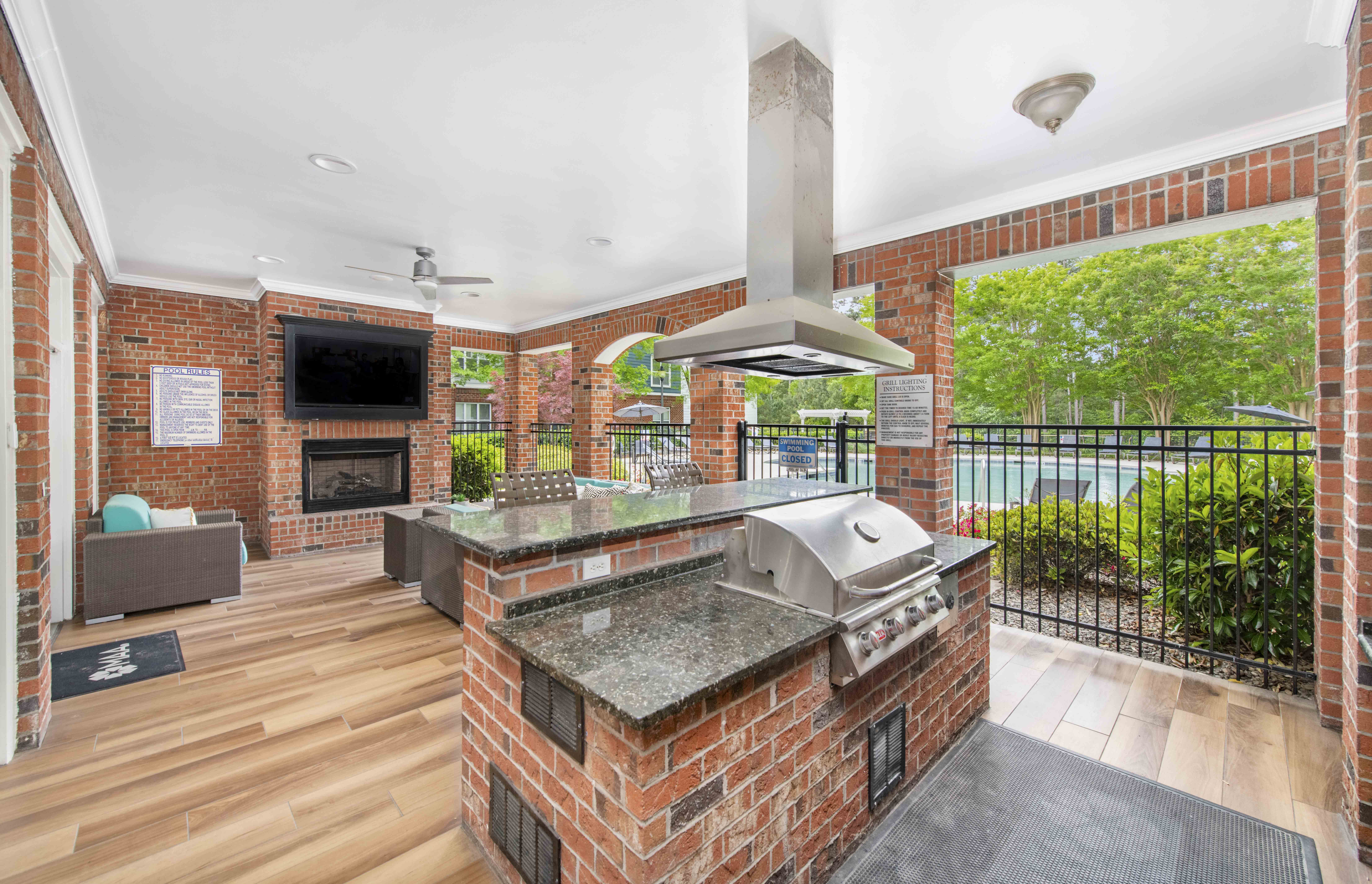the kitchen has a large island with a stone countertop and a fireplace